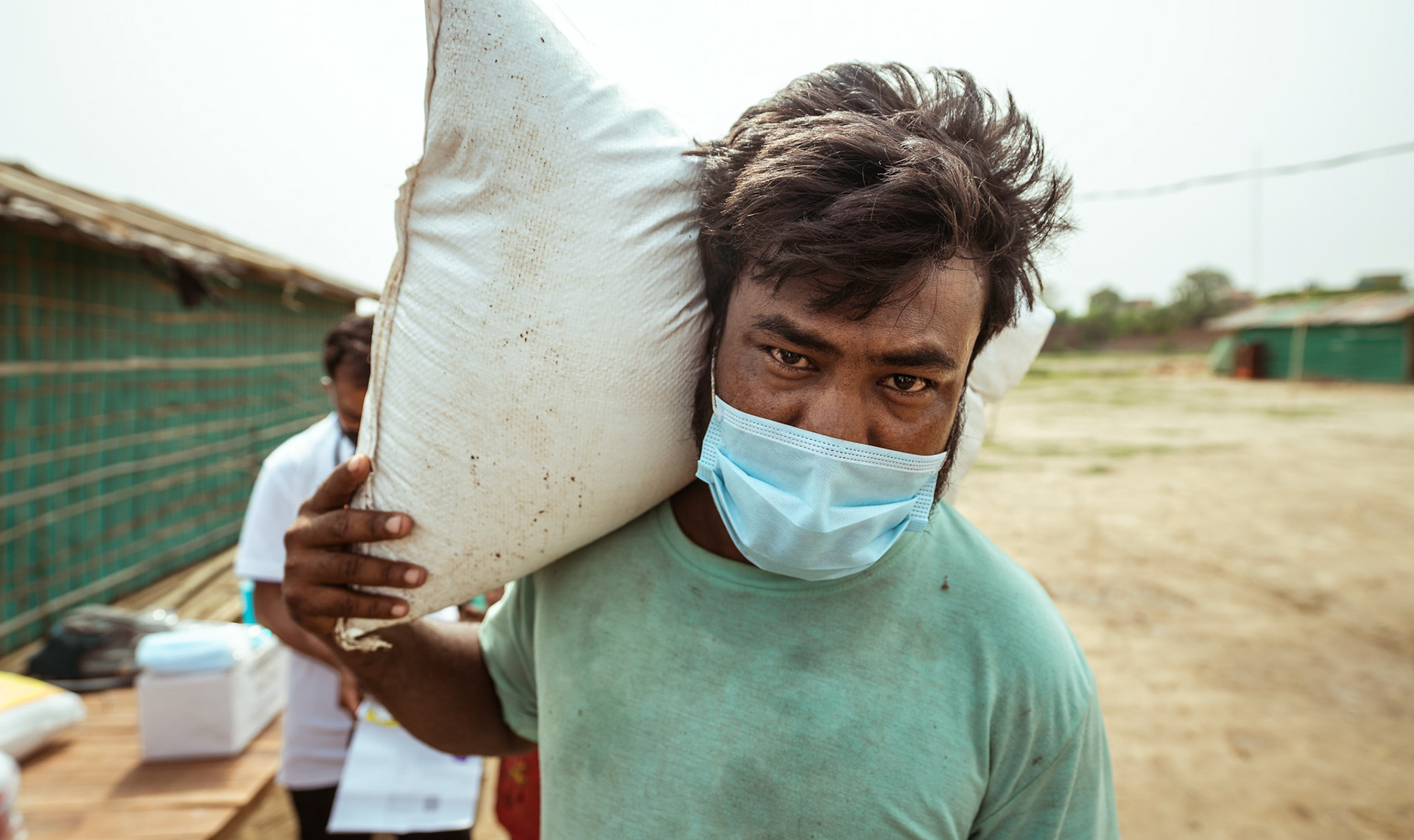 A beneficiary carrying home the basic need supplies and COVID relief kit distributed by Catholic Relief Services (CRS) as a part of COVID-19 Response and Recovery Program in Mewat, Haryana.