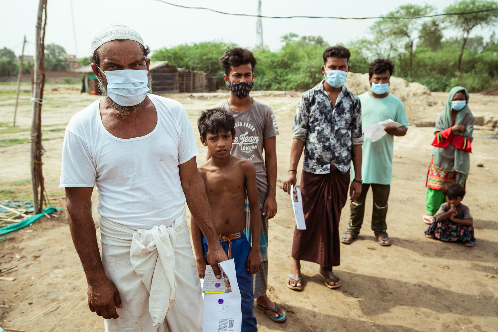 Refugees waiting in que to collect basic need supplies being distributed by Catholic Relief Services (CRS) as a part of COVID-19 Response and Recovery Program in Mewat, Haryana.