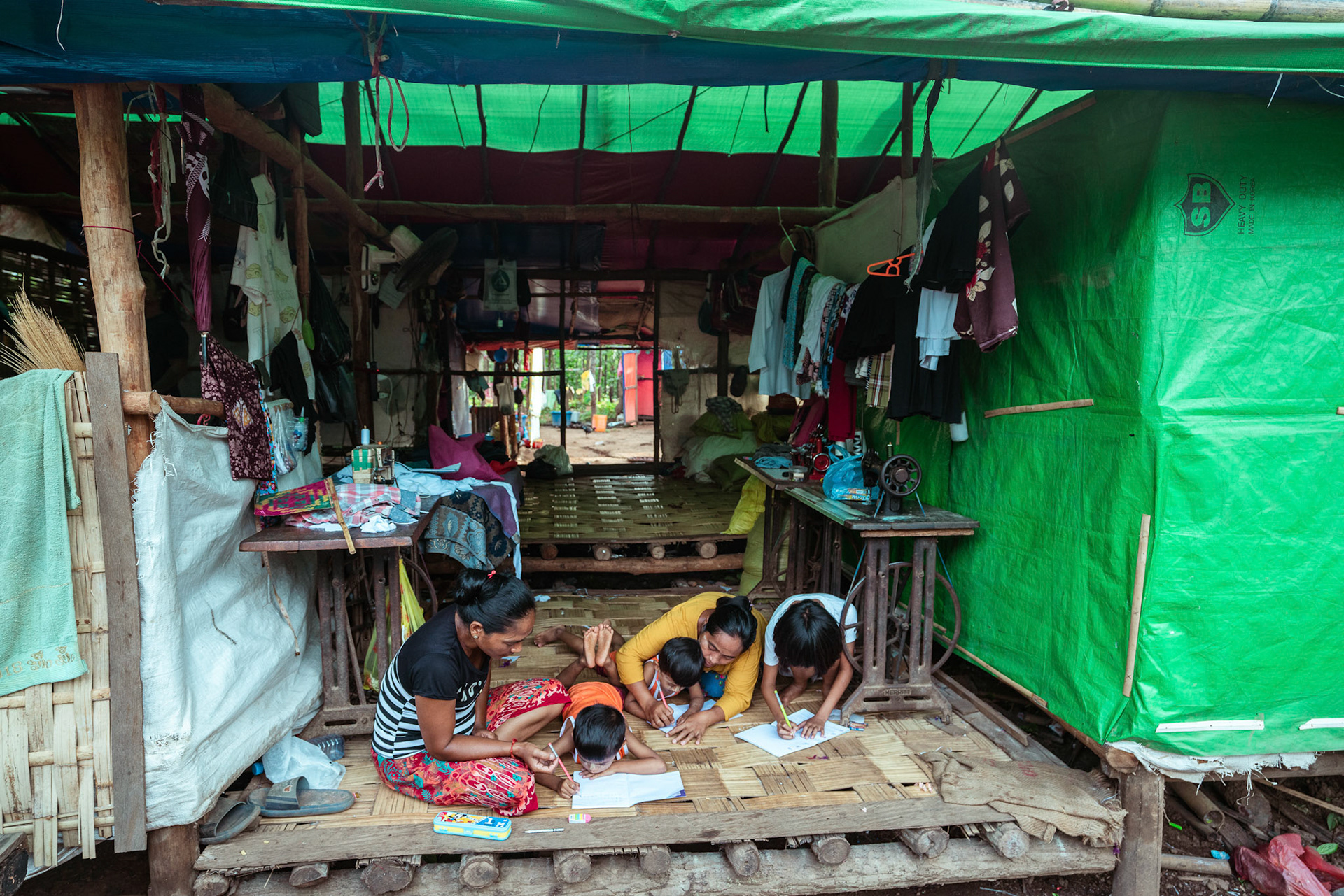 Mothers tutoring their children after attending skill development and adult education modules organised by members of CRS in Moreh, Manipur.