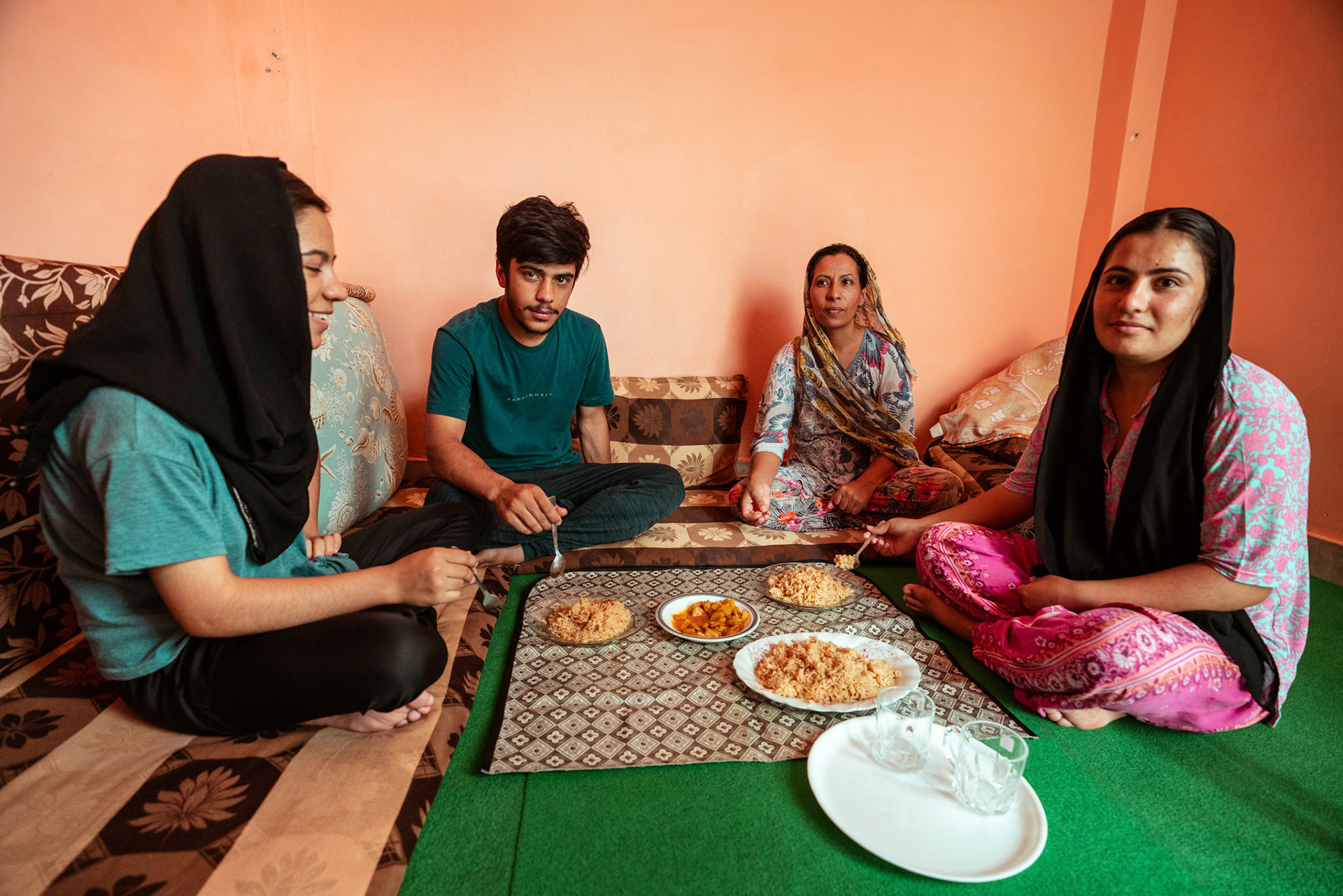 Afghan Refugees in Tilak Nagar, Delhi, share a meal during the relief project organised by Catholic Relief Services (CRS)