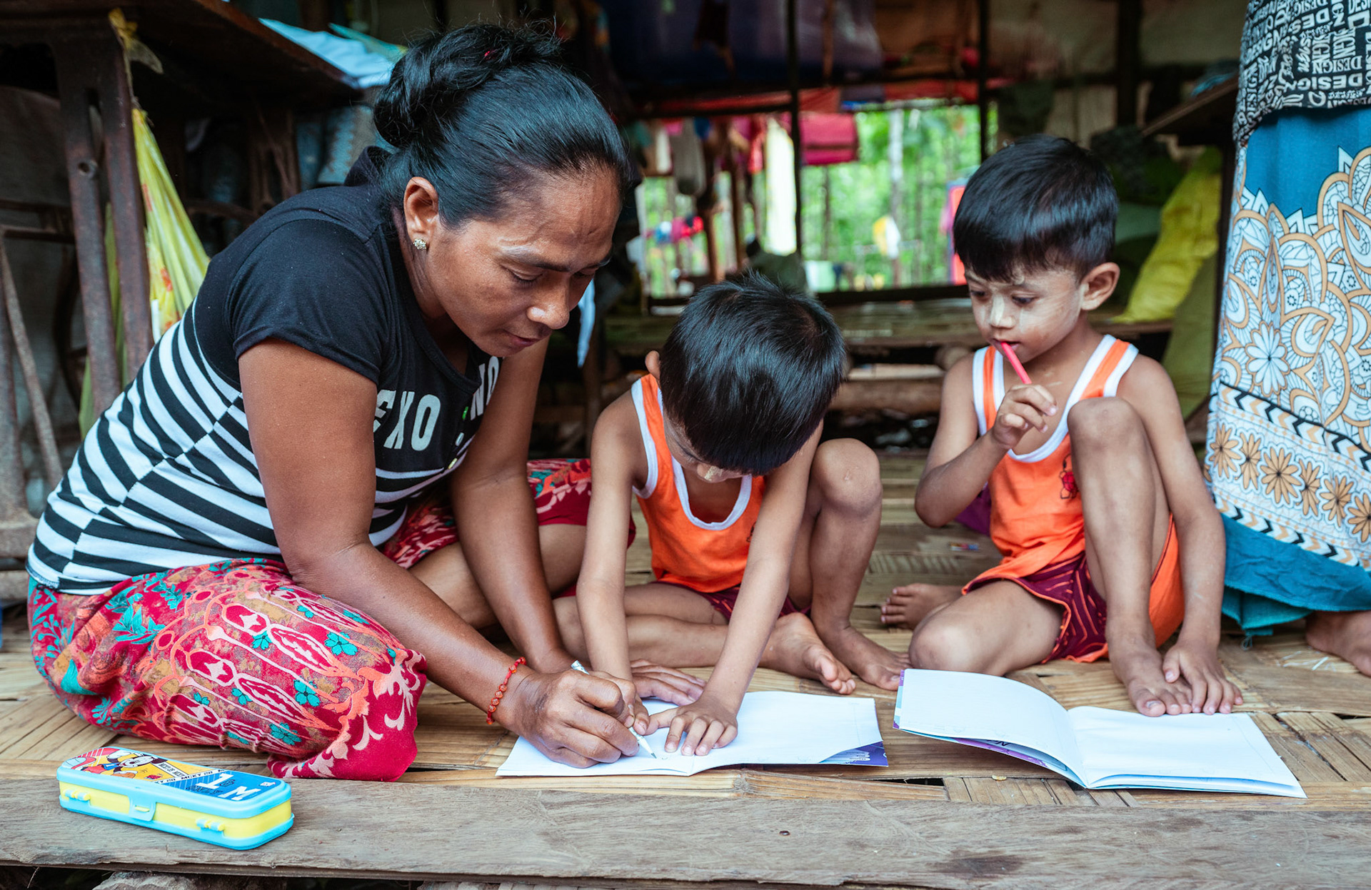 Mothers tutoring their children after attending skill development and adult education modules organised by members of CRS in Moreh, Manipur.
