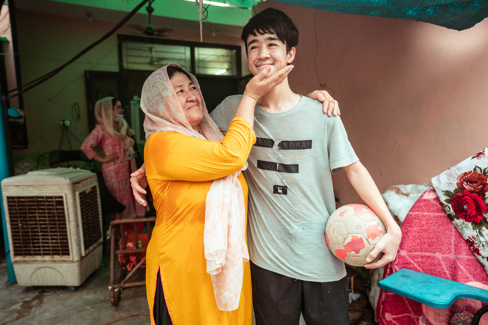 An Afghan refugee with her son at their house in Tilak Nagar, Delhi.