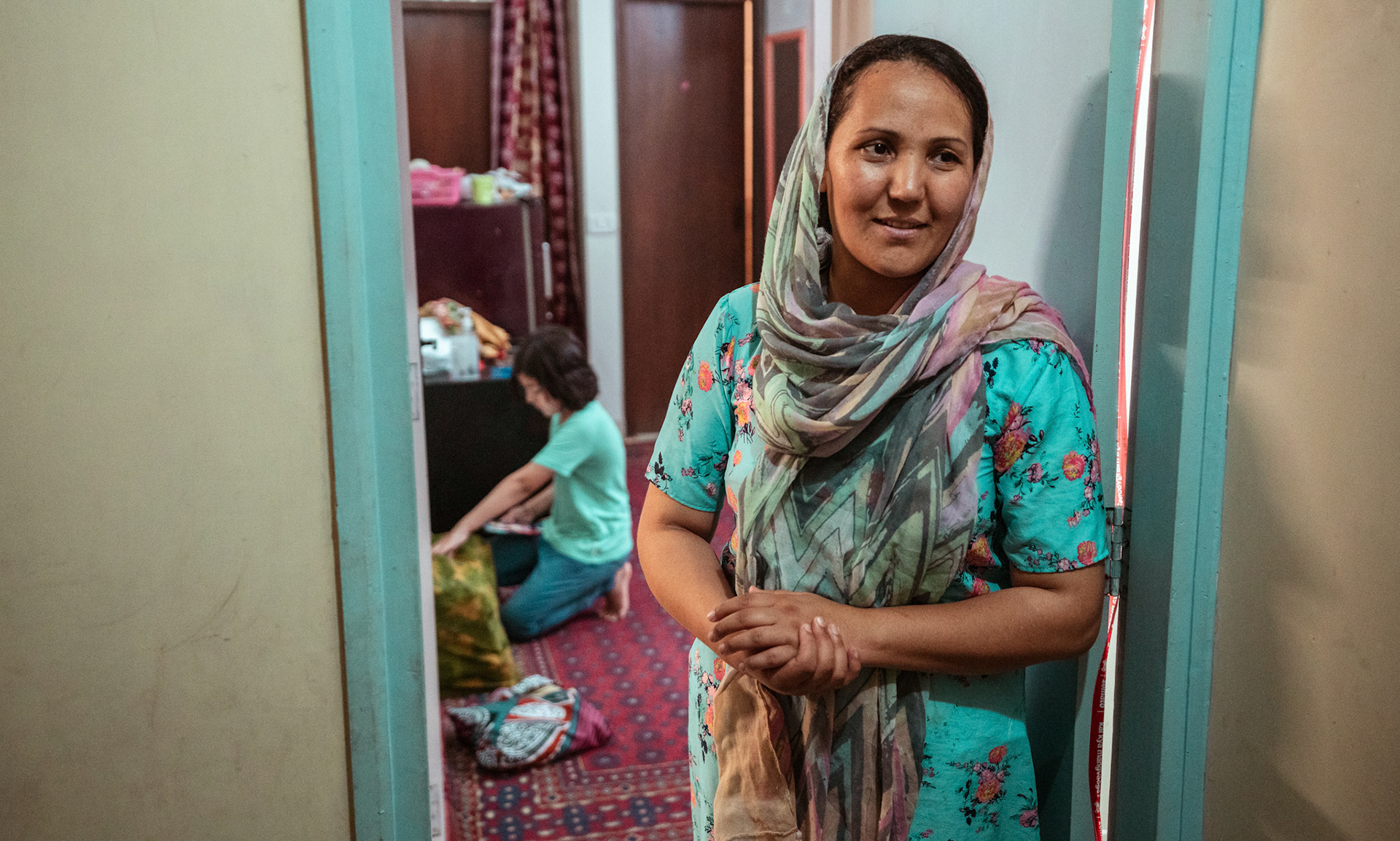 An Afghan Refugee stands at her home in Tilak Nagar, Delhi, during the relief project organised by Catholic Relief Services (CRS)