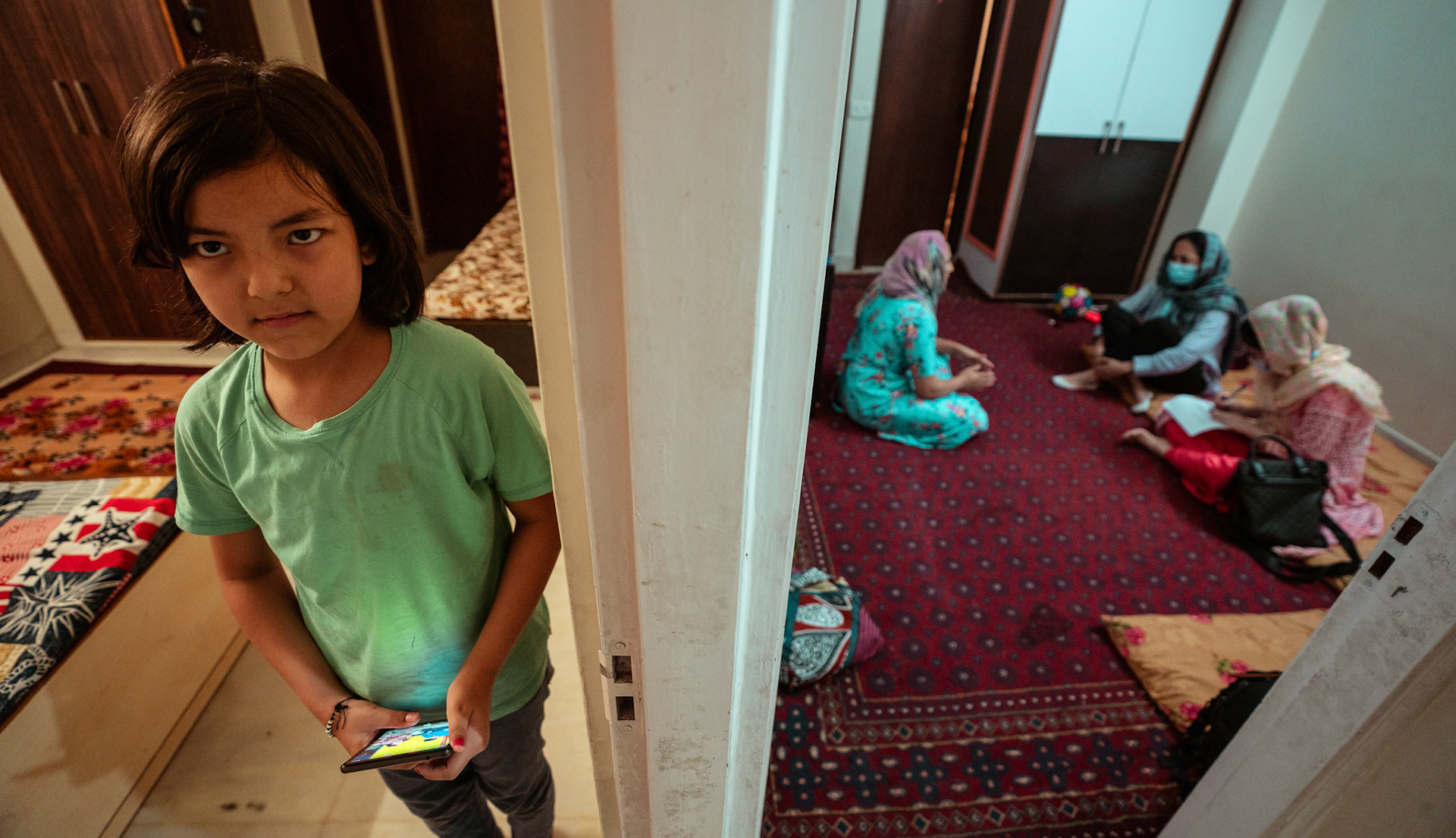 Representatives of Catholic Relief Services (CRS) speaking to a refugee in Tilak Nagar, Delhi about COVID Appropriate Behaviour, Gender based violence and child protection.