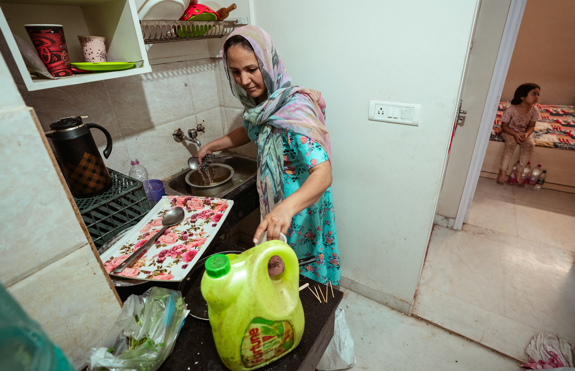 An Afghan Refugee prepares a meal in Tilak Nagar, Delhi, during the relief project organised by Catholic Relief Services (CRS)