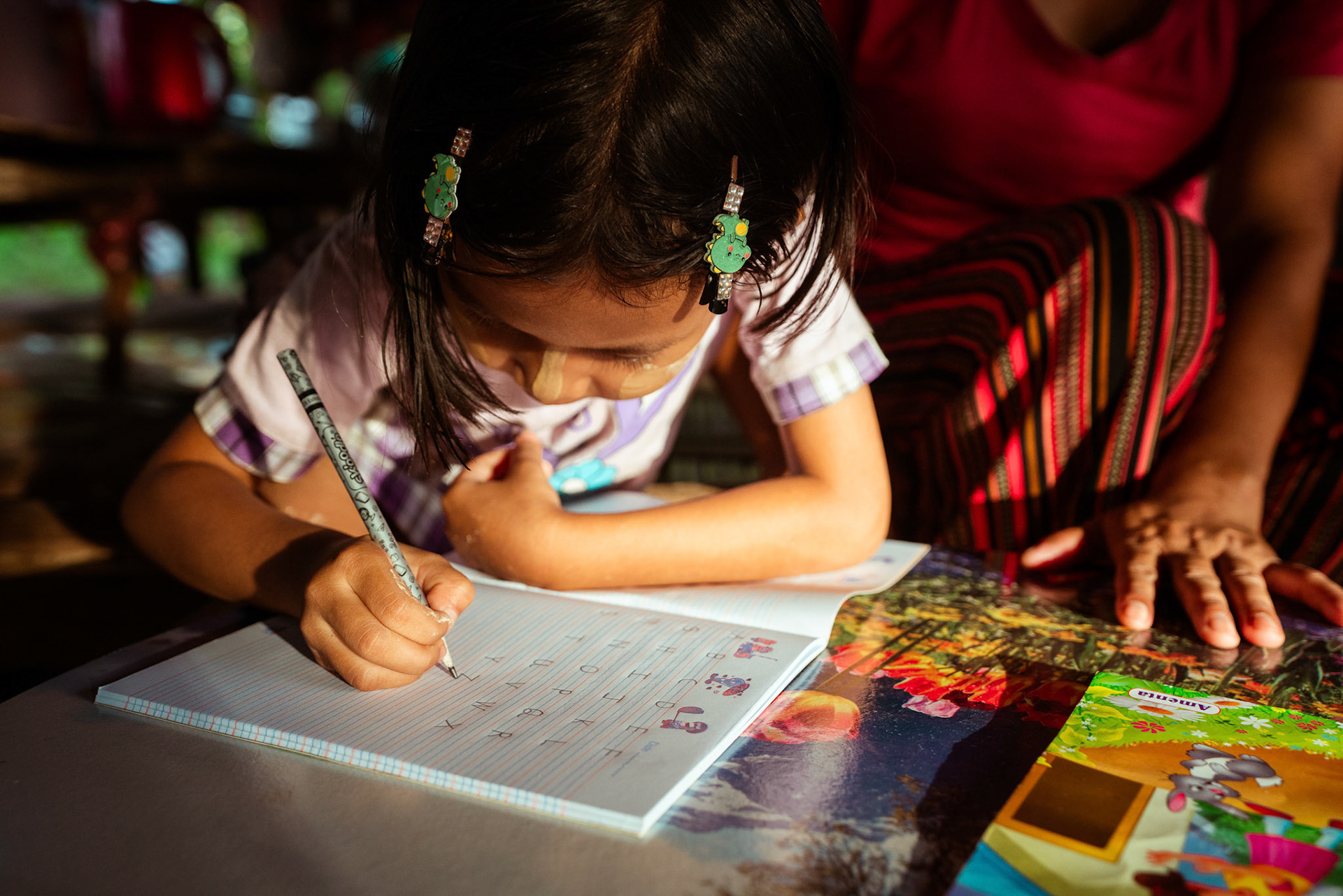 Mothers tutoring their children after attending skill development and adult education modules organised by members of CRS in Moreh, Manipur.