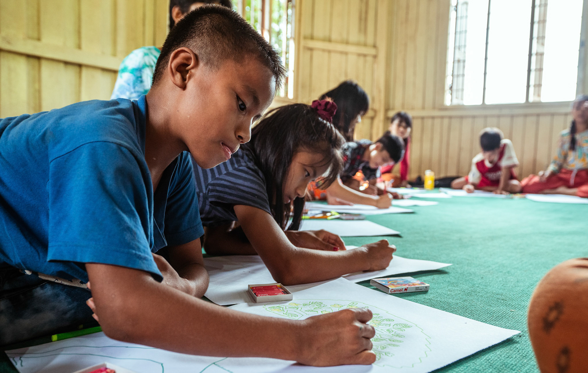 Refugee children during the 'Tree of life' sessions organised by Catholic Relief Services (CRS) in Moreh, Manipur.The “Tree of Life” is a psychosocial support tool based on narrative practices that is designed to help participants accept the hardships of their past and identify the strengths that can help them a