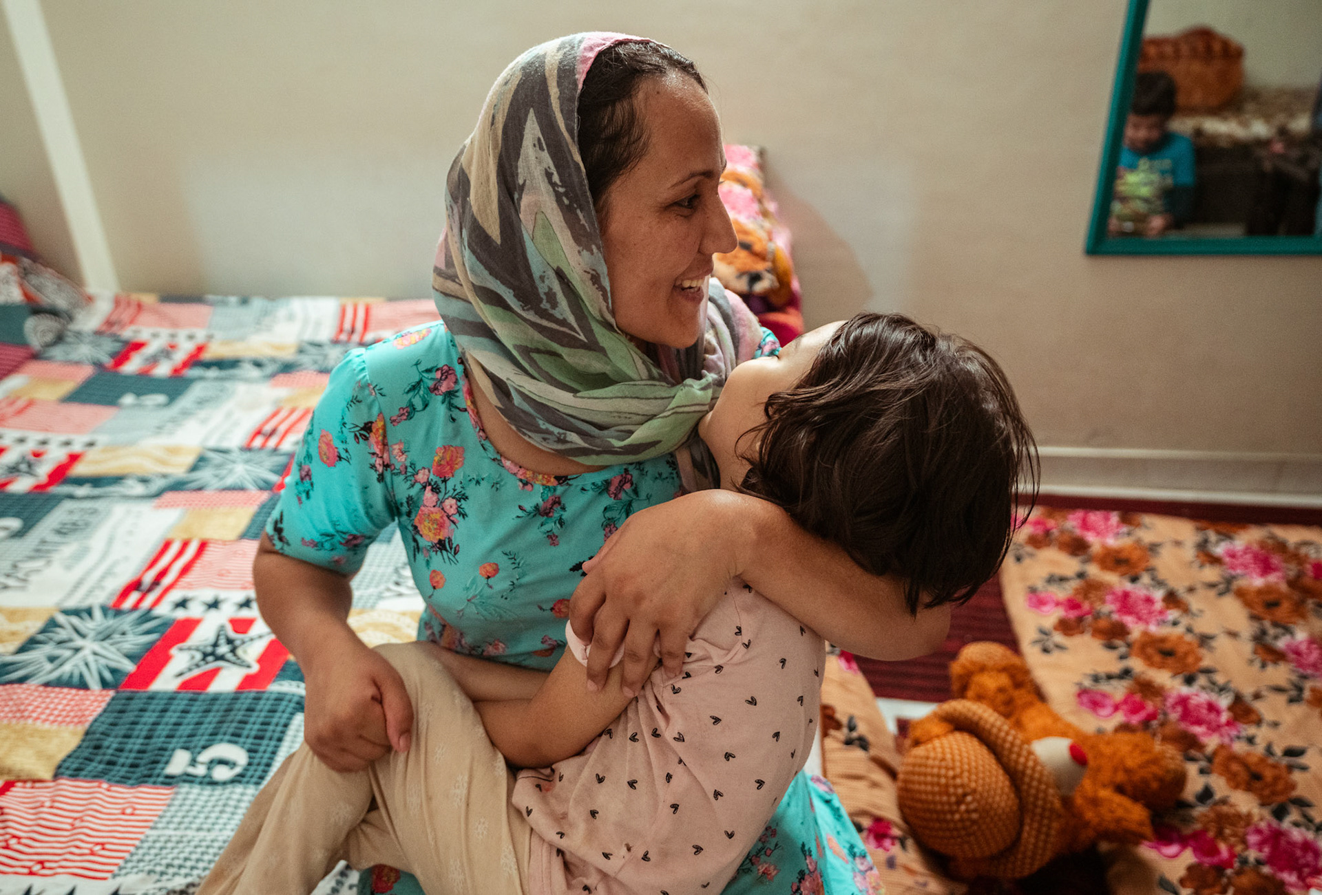 An Afghan Refugee spends time with her children in Tilak Nagar, Delhi, during the relief project organised by Catholic Relief Services (CRS)