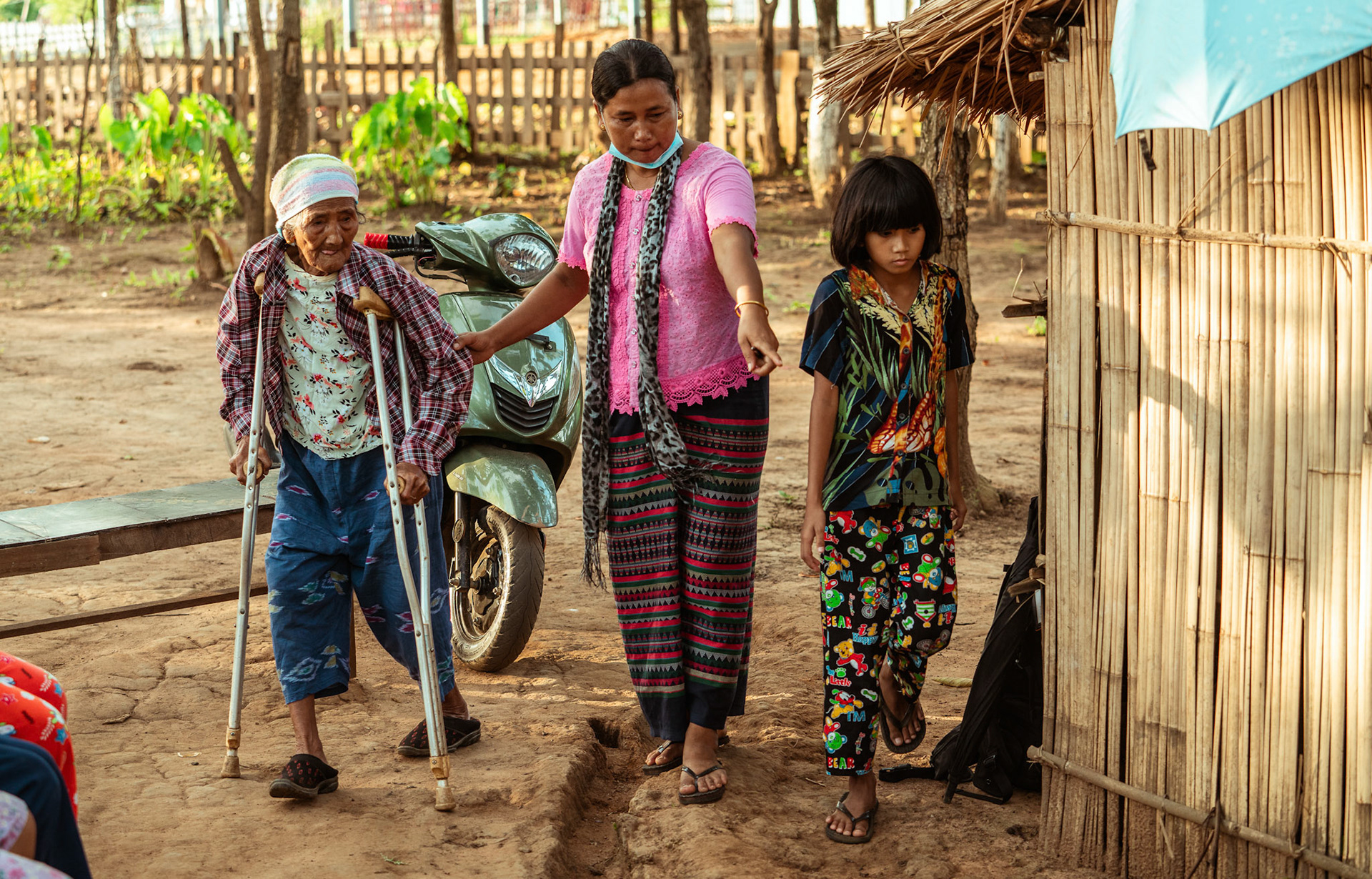 A old refugee woman being helped to attend a medical check-up in Moreh, Manipur, at the medical camp organised by Catholic Relief Services.