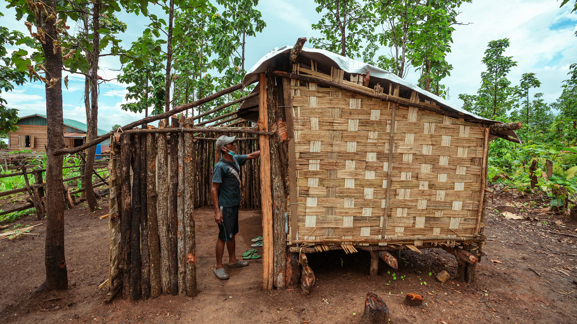 Refugees in Moreh, Manipur, covering their roof with tarpaulin sheets received from the Voucher Based Distribution of basic need supplies and COVID recovery kits among People of Concern (POC) in Moreh, Manipur organised by Catholic Relief Services (CRS).