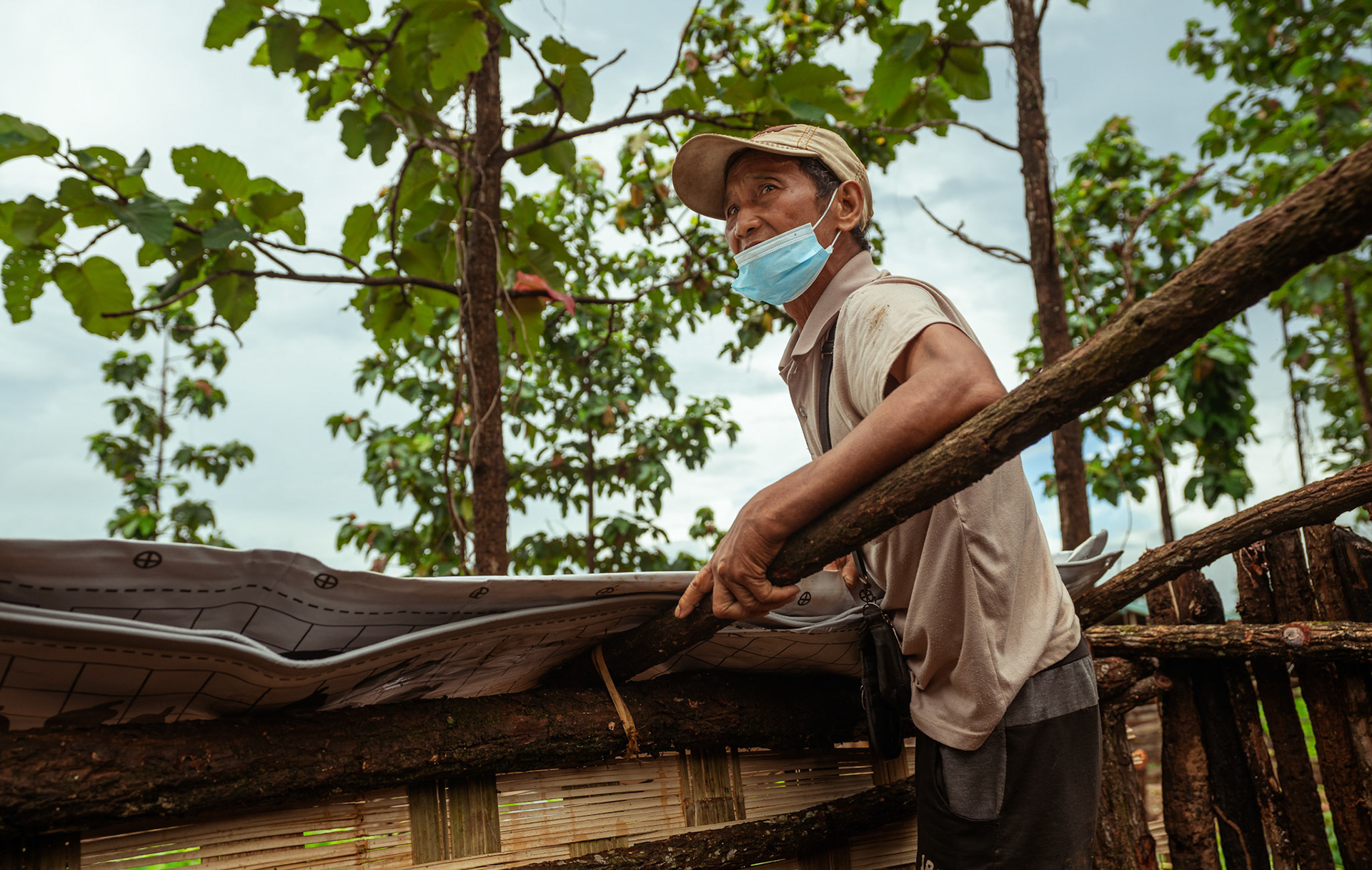 Refugees in Moreh, Manipur, covering their roof with tarpaulin sheets received from the Voucher Based Distribution of basic need supplies and COVID recovery kits among People of Concern (POC) in Moreh, Manipur organised by Catholic Relief Services (CRS).