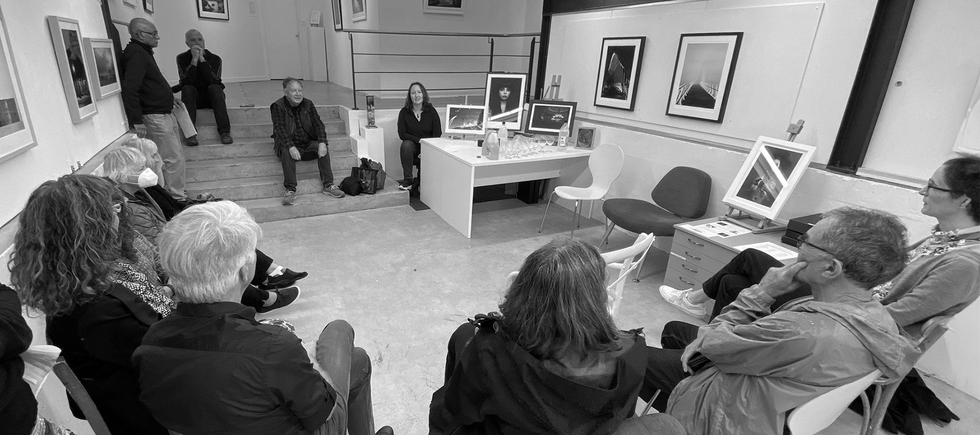 Charlotte gives an artist talk to a group of people at a local gallery as part of a group exhibition for the Auckland Festival of Photography 2022