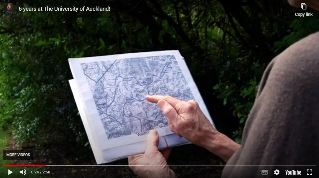 Still screenshot image from a youtube video which shows a hand pointing at a map