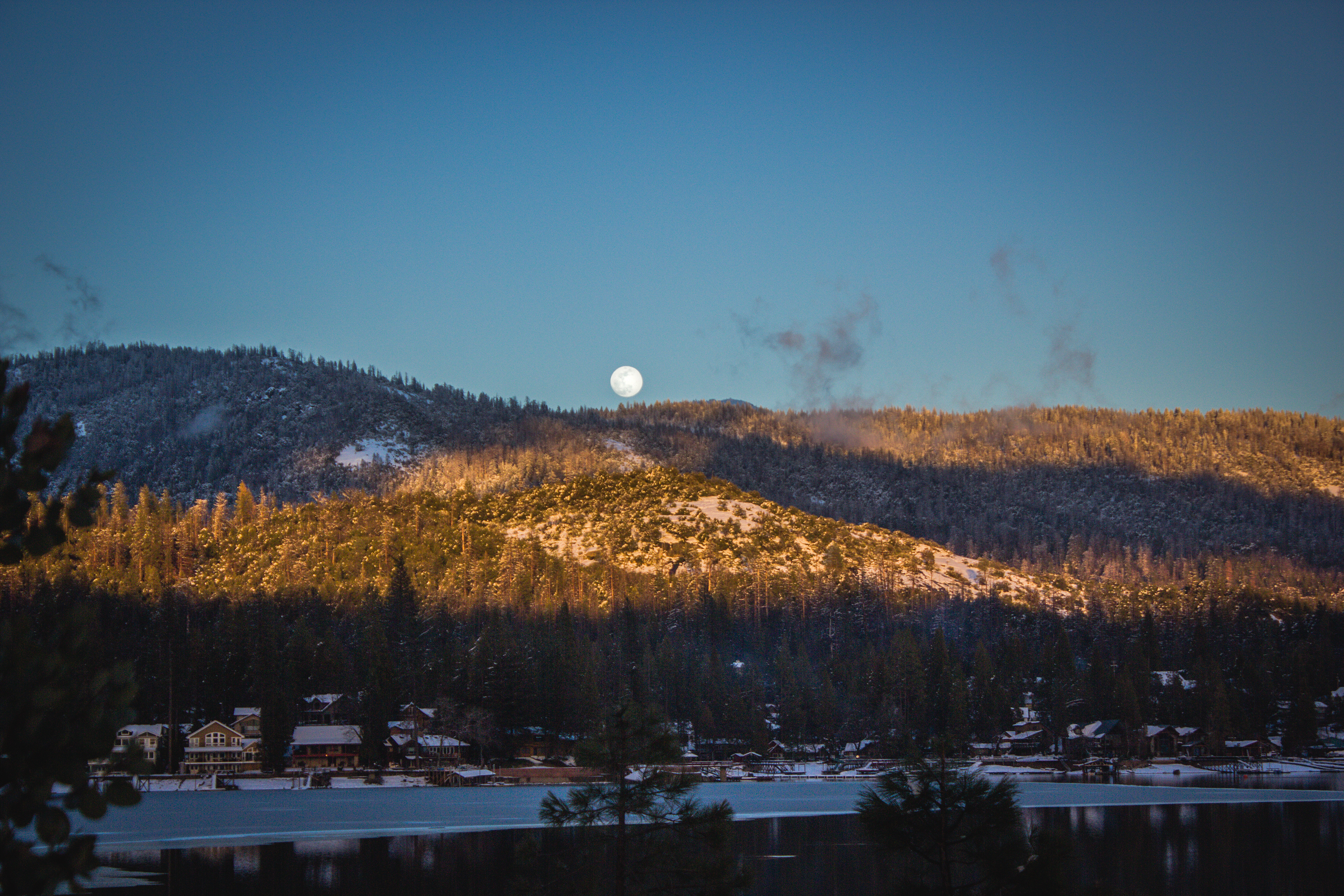 Full moon rises over Bass Lake, CA