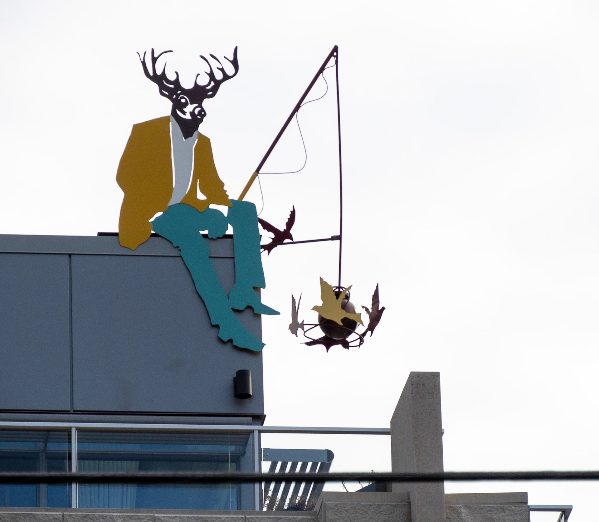 fishing from rooftop sculpture