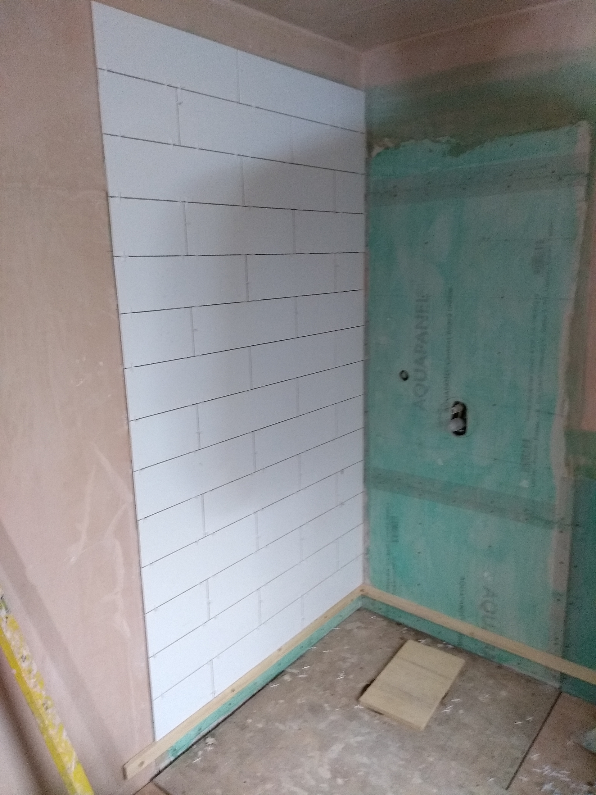 Plastering finished, walls primed and tiling started