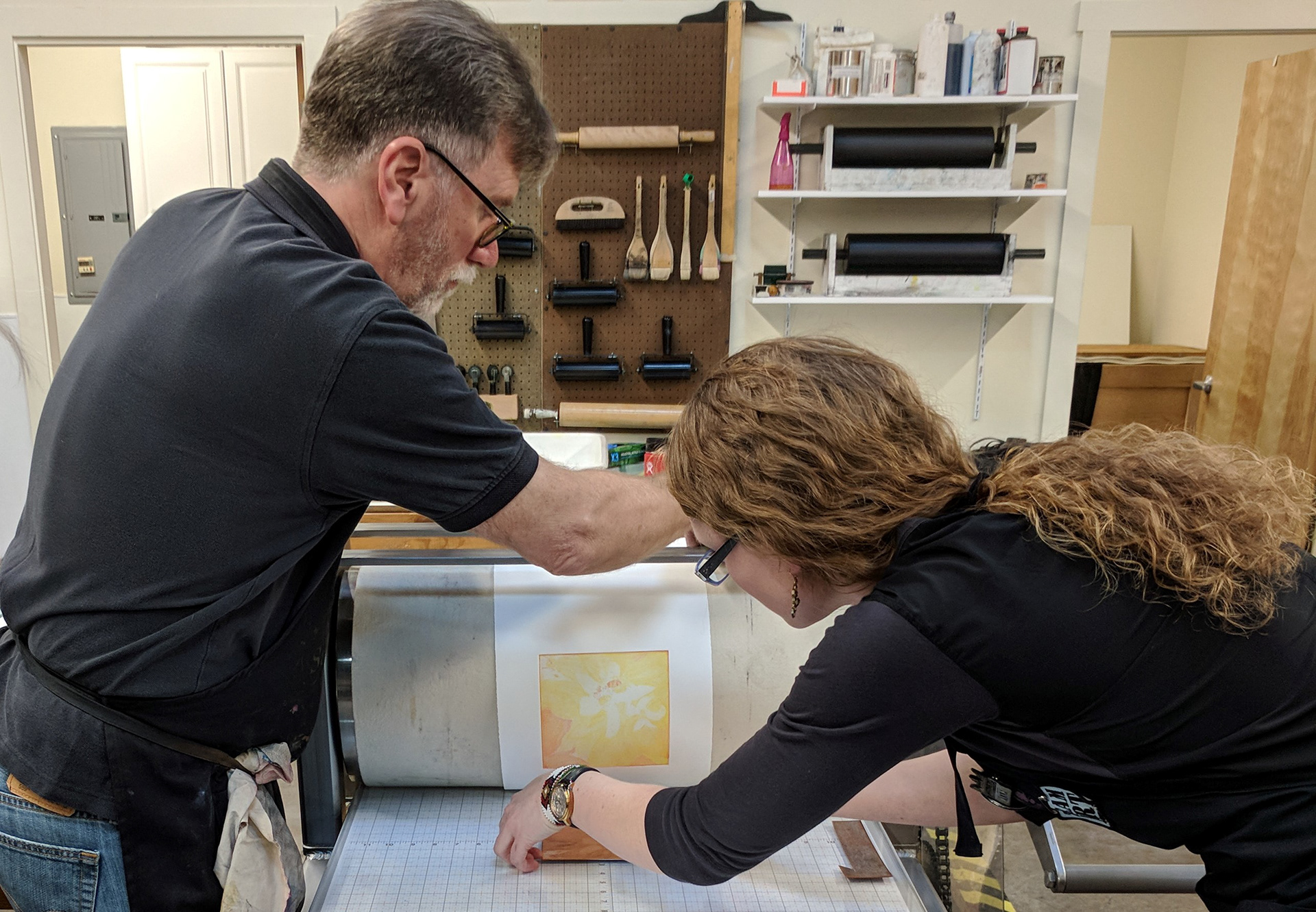 Lawrence Hamlin, visiting artist, and Anna Hansen, SG and Bogue Foundry member, printing a multiple plate color etching.