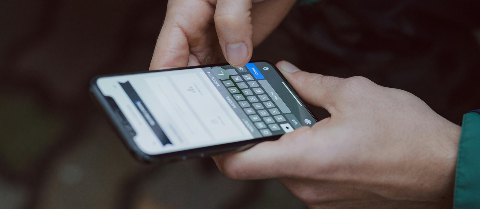 Image depicting a person's hands texting on a smartphone