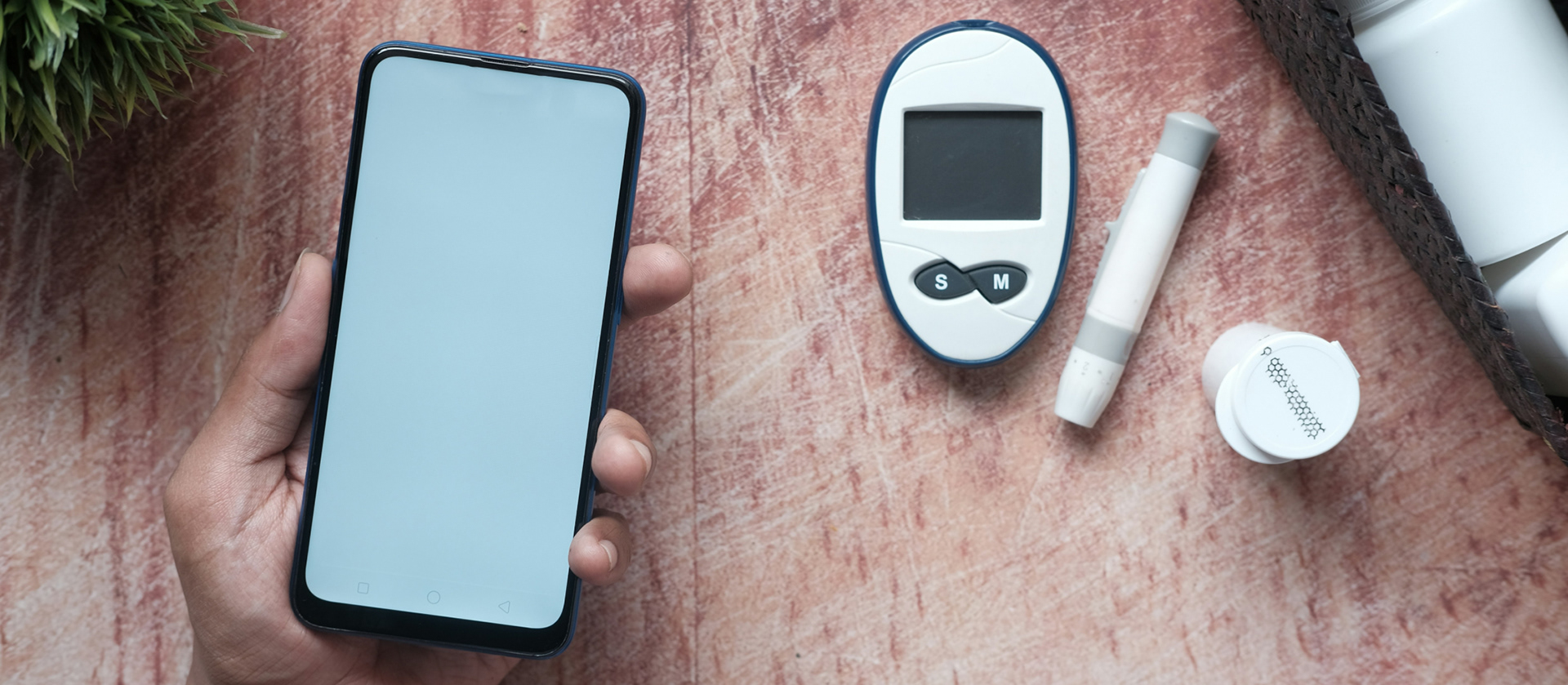 Image of a blood glucometer connecting to a mobile phone