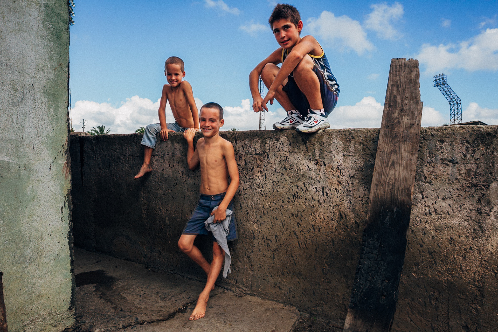 Jatibonico, Cuba — January 1, 2012. On the 54th anniversary of the Cuban Revolution, Yakeline has spent four years waiting for the state housing allocation she was promised. In the meantime, she and her husband raise their five children in the old baseball stadium’s scoreboard building—one room for sleeping, the upper level improvised as a bathroom. With no running water or electricity, they rely on neighbors while hoping for something better.