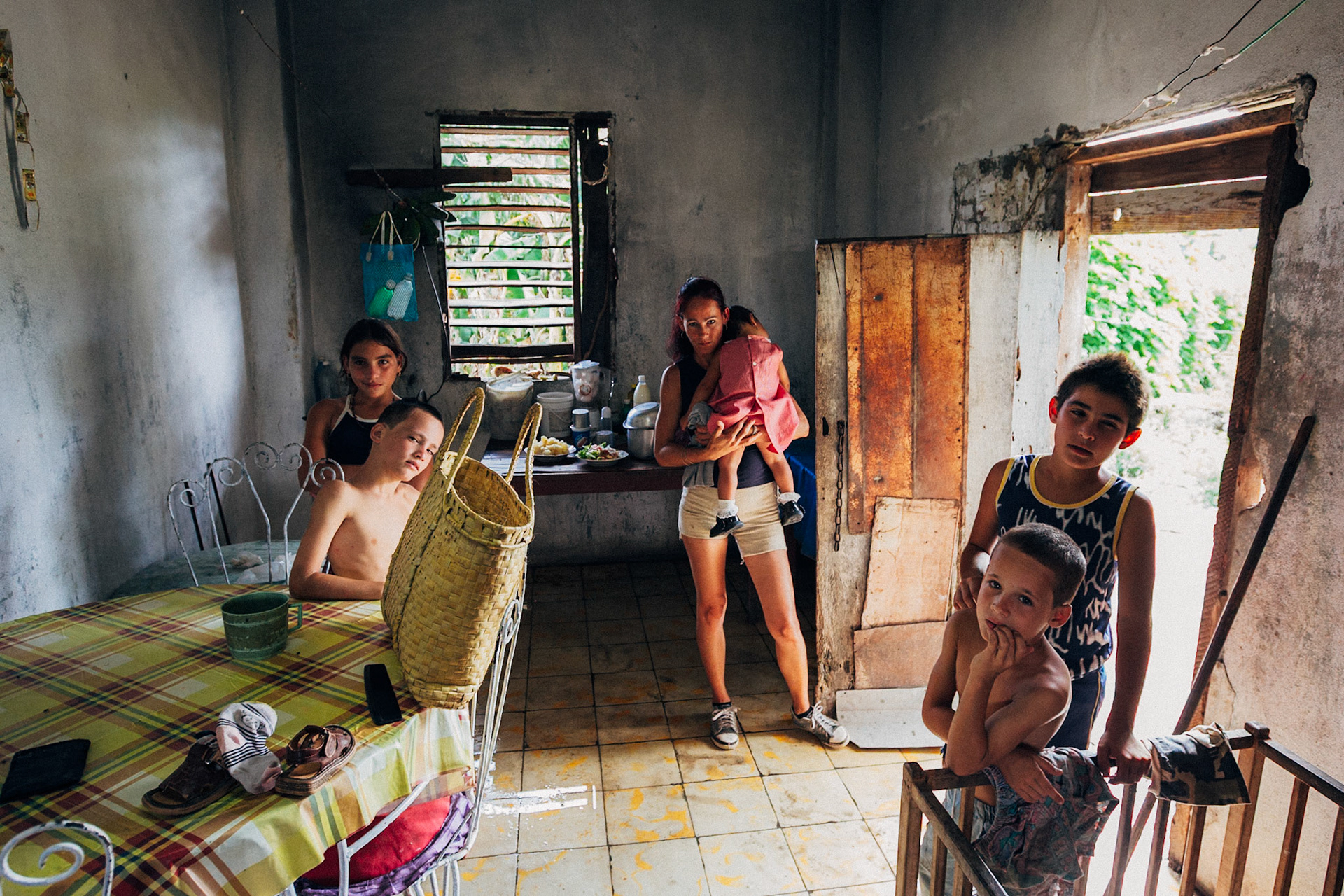 Jatibonico, Cuba — January 1, 2012. On the 54th anniversary of the Cuban Revolution, Yakeline has spent four years waiting for the state housing allocation she was promised. In the meantime, she and her husband raise their five children in the old baseball stadium’s scoreboard building—one room for sleeping, the upper level improvised as a bathroom. With no running water or electricity, they rely on neighbors while hoping for something better.