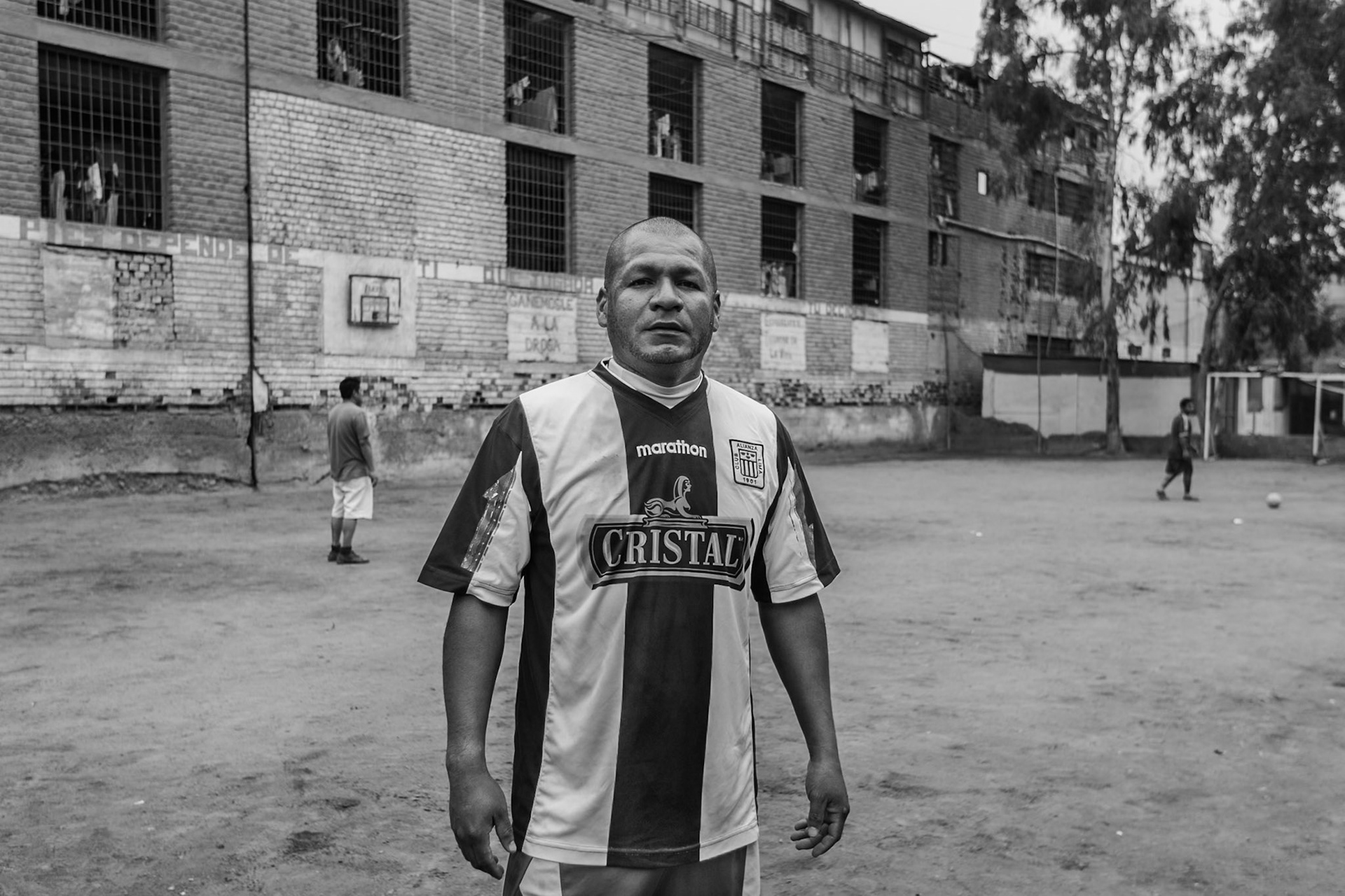 LURIGANCHO PRISON, SAN JUAN DE LURIGANCHO, LIMA, PERU: A former inmate who now works as a social worker poses during halftime of a soccer match between prisoners as an integration initiative.