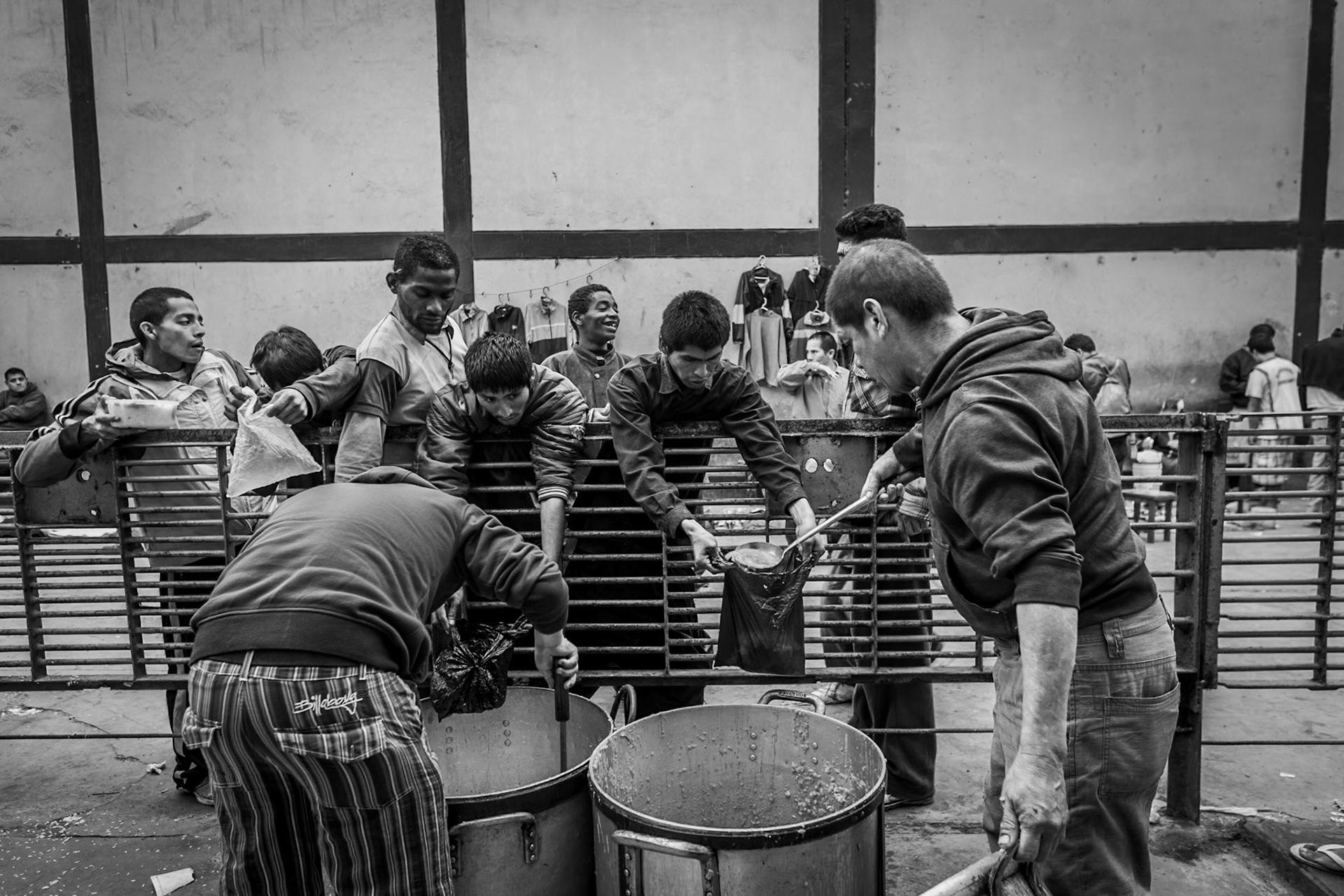 LURIGANCHO PRISON, SAN JUAN DE LURIGANCHO, LIMA, PERU, 2012: Inmates with fewer resources and who cannot afford their own food receive a ration of leftover food from each cellblock.