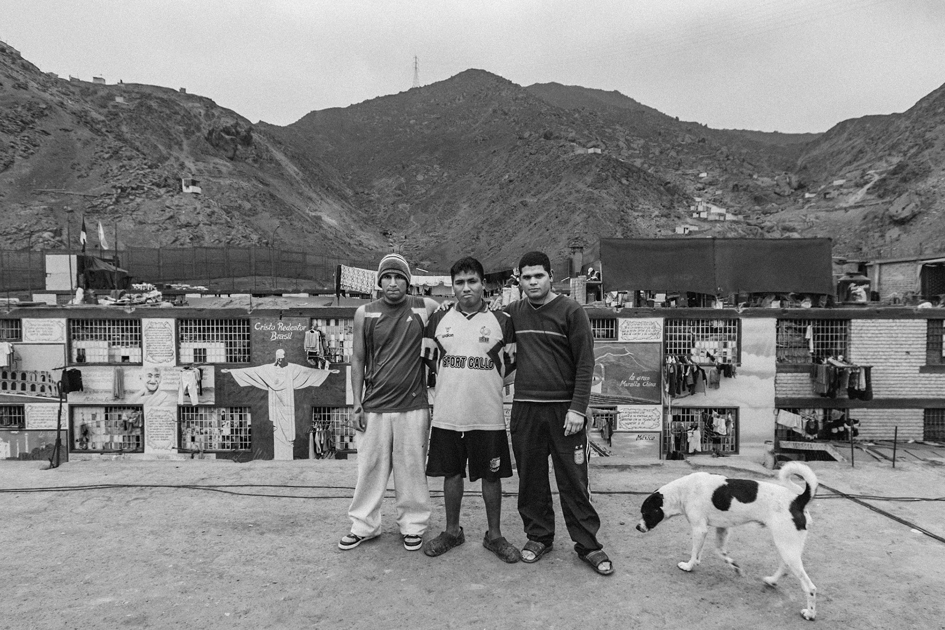 LURIGANCHO PRISON, SAN JUAN DE LURIGANCHO, LIMA, PERU: Three young prisoners posing on the prison roof with a mascot.