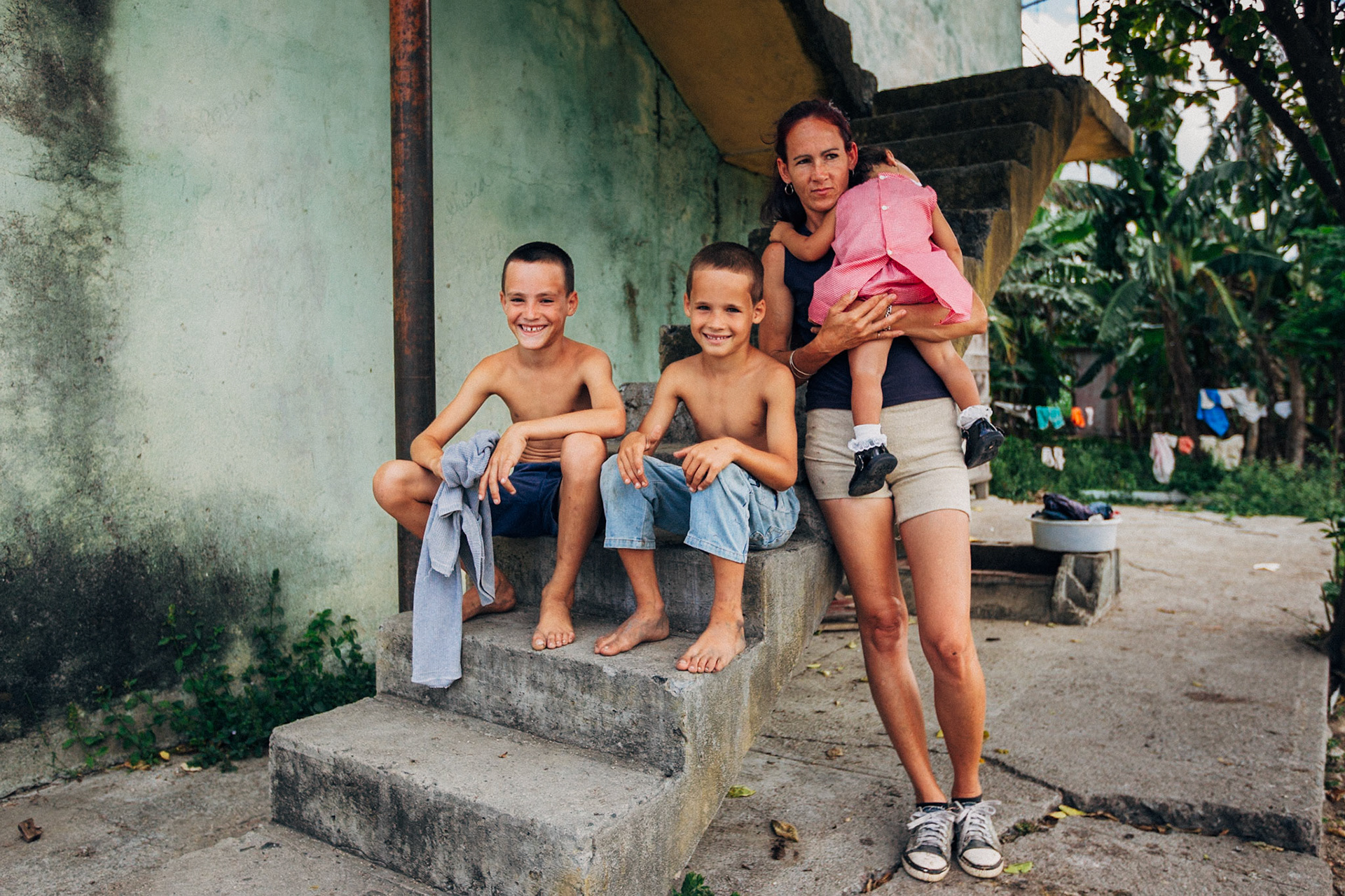 Jatibonico, Cuba — January 1, 2012. On the 54th anniversary of the Cuban Revolution, Yakeline has spent four years waiting for the state housing allocation she was promised. In the meantime, she and her husband raise their five children in the old baseball stadium’s scoreboard building—one room for sleeping, the upper level improvised as a bathroom. With no running water or electricity, they rely on neighbors while hoping for something better.
