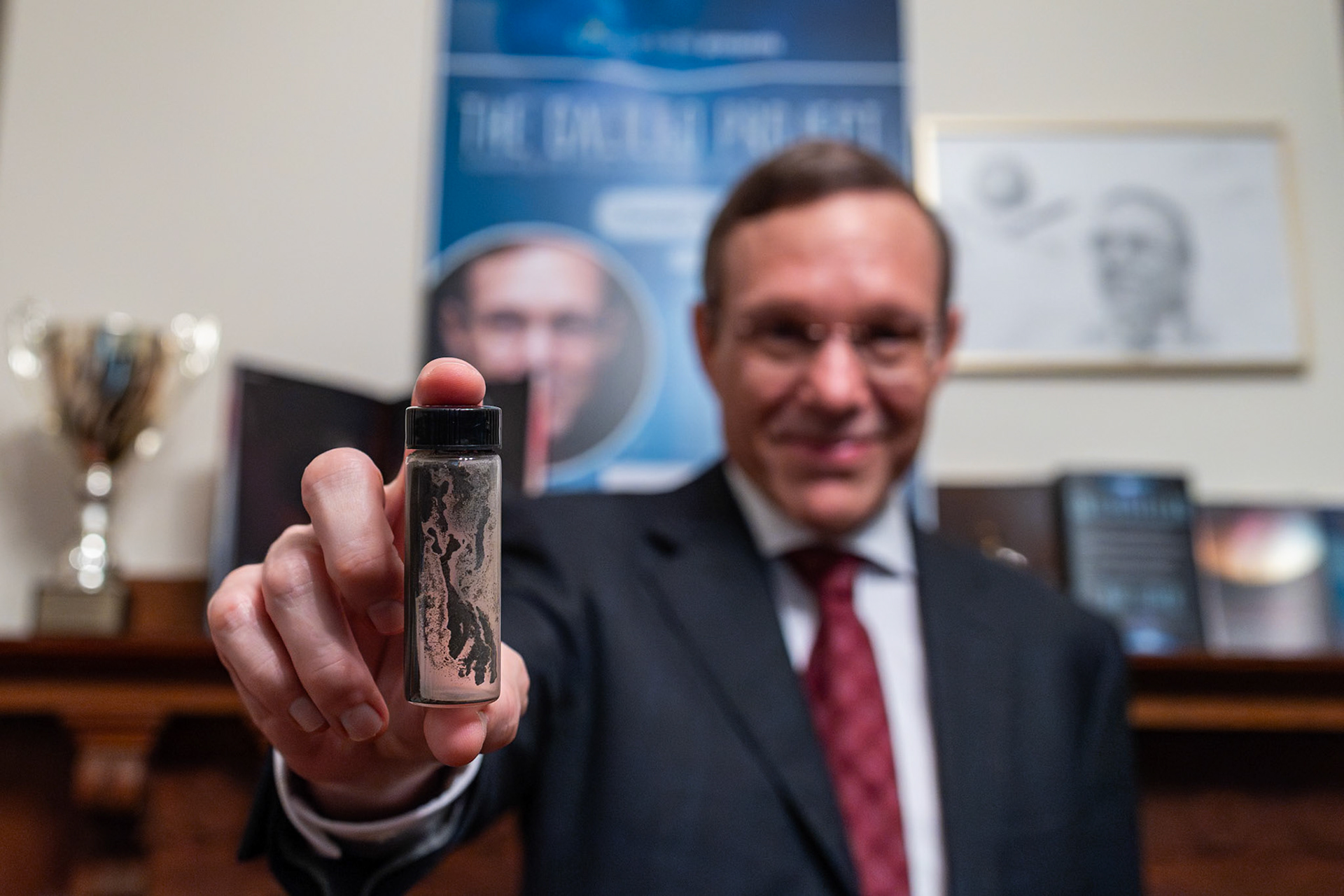 LEXINGTON, MA, USA - AUGUST 8: Abraham 'Avi' Loeb, a Harvard University astrophysicist shows a tube containing meteorite fragments recovered from the bottom of the Pacific Ocean. at his home in Lexington, Massachusetts, United States on August 8, 2023. Abraham 'Avi' Loeb claims that the meteorite fragments recovered from the ocean floor could belong to a spacecraft.
