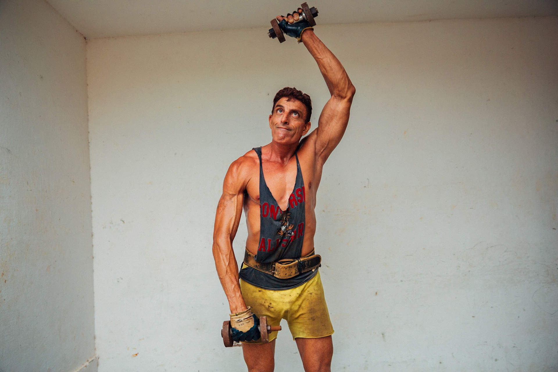 Strongman exercising muscles, Cojímar, Havana, Cuba.