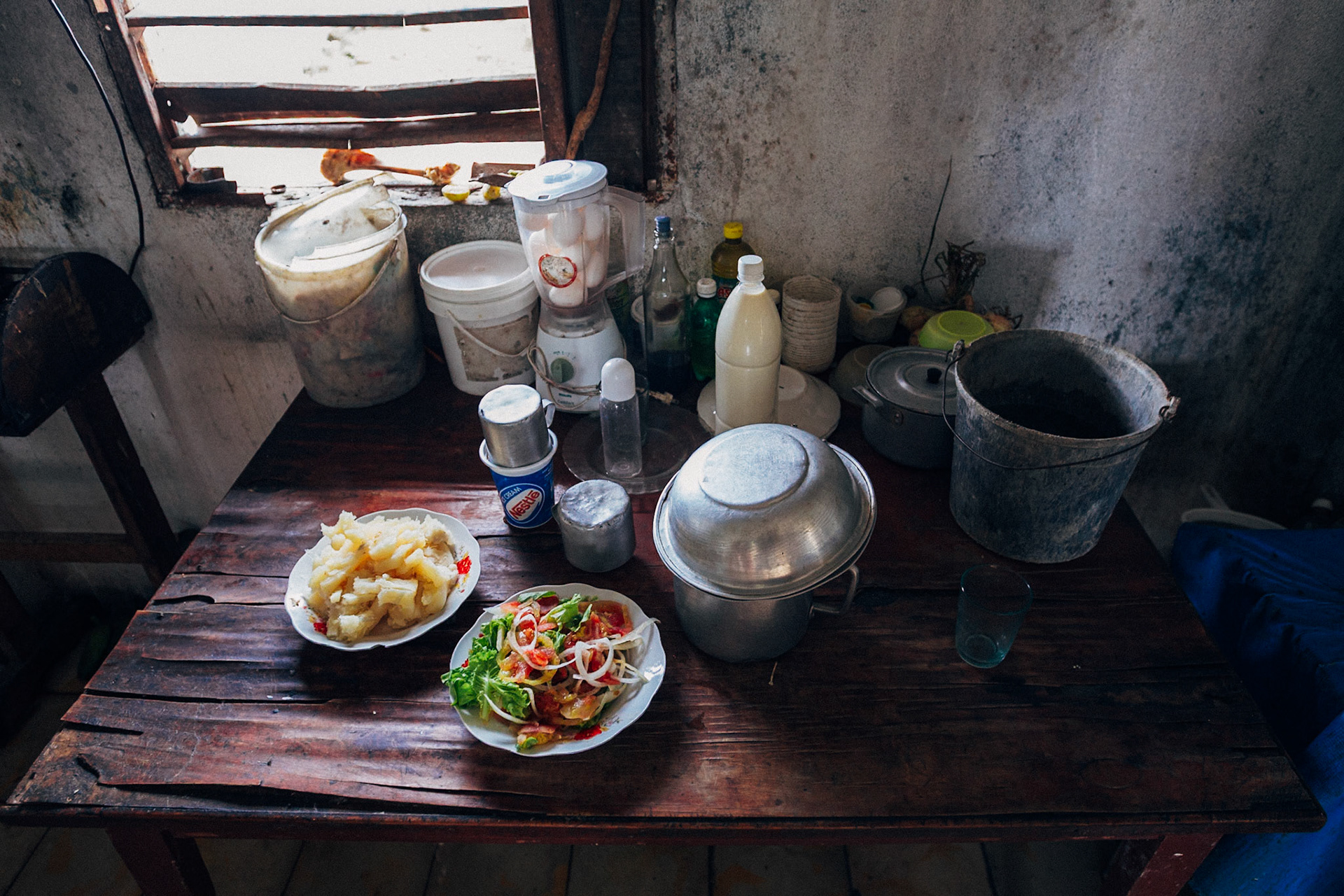 Jatibonico, Cuba — January 1, 2012. On the 54th anniversary of the Cuban Revolution, Yakeline has spent four years waiting for the state housing allocation she was promised. In the meantime, she and her husband raise their five children in the old baseball stadium’s scoreboard building—one room for sleeping, the upper level improvised as a bathroom. With no running water or electricity, they rely on neighbors while hoping for something better.