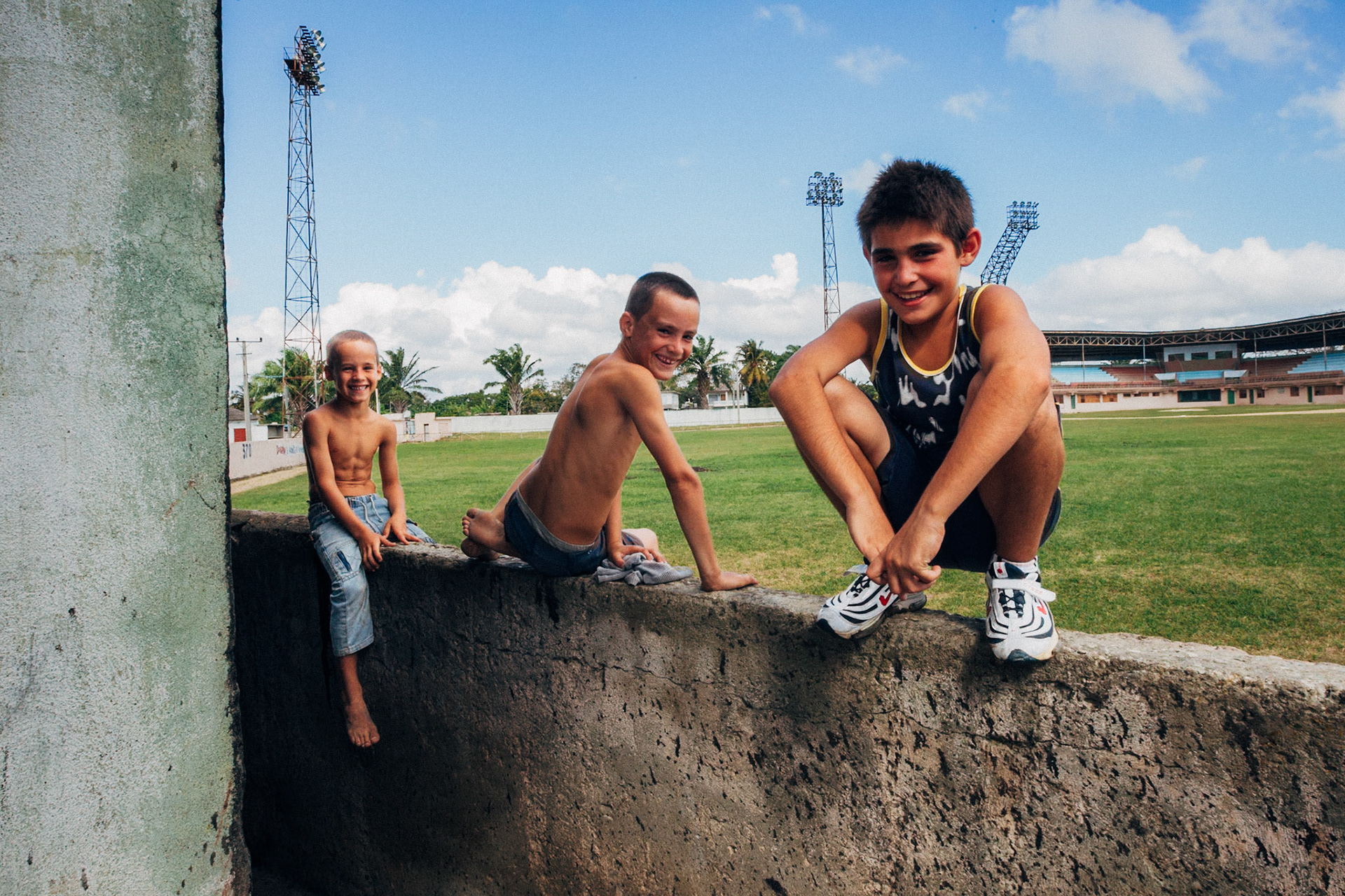 Jatibonico, Cuba — January 1, 2012. On the 54th anniversary of the Cuban Revolution, Yakeline has spent four years waiting for the state housing allocation she was promised. In the meantime, she and her husband raise their five children in the old baseball stadium’s scoreboard building—one room for sleeping, the upper level improvised as a bathroom. With no running water or electricity, they rely on neighbors while hoping for something better.