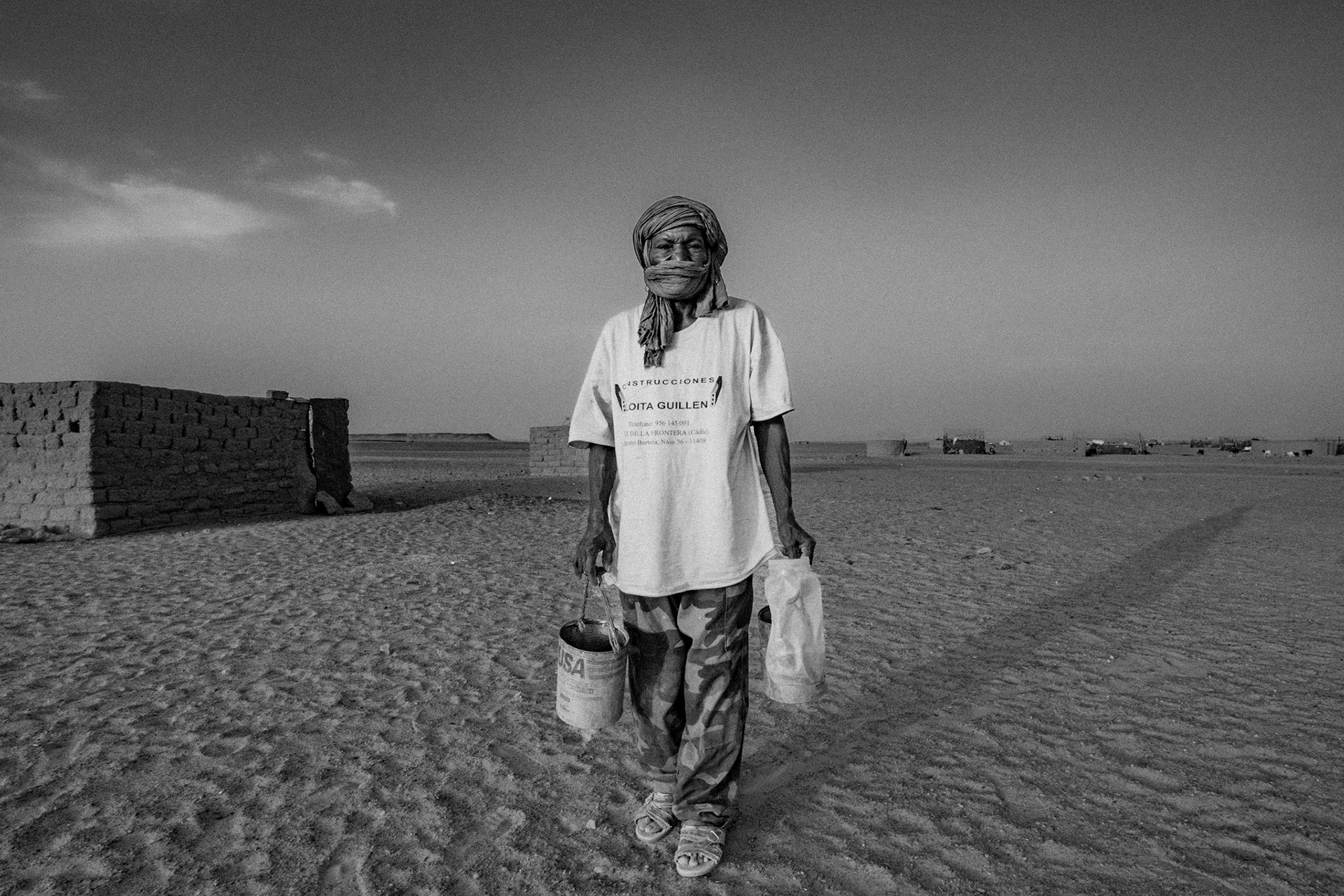 Dakhla refugee camp, Tindouf, Wilaya de Tindouf, Algerian Sahara, 2009: Man with food for animals.