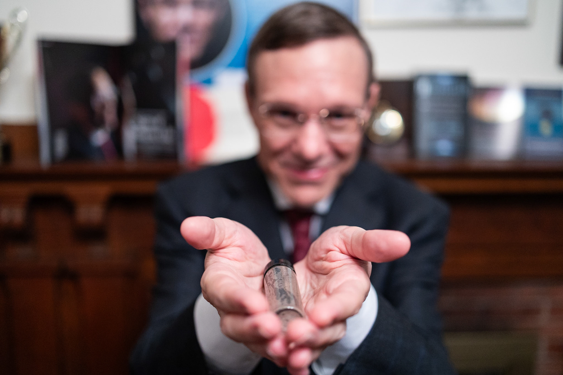 LEXINGTON, MA, USA - AUGUST 8: Abraham 'Avi' Loeb, a Harvard University astrophysicist shows a tube containing meteorite fragments recovered from the bottom of the Pacific Ocean at his home in Lexington, Massachusetts, United States on August 8, 2023. Abraham 'Avi' Loeb claims that the meteorite fragments recovered from the ocean floor could belong to a spacecraft.