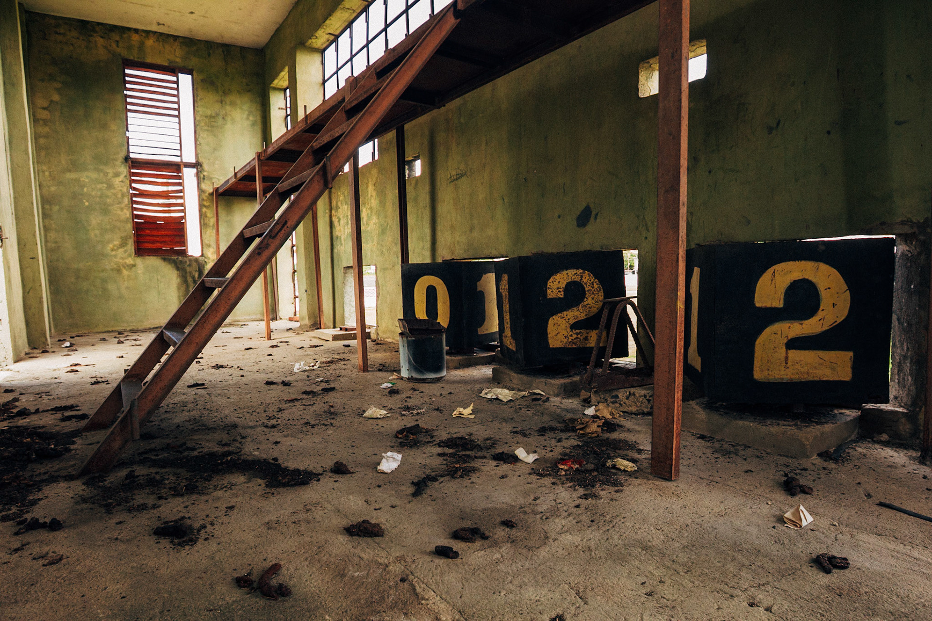 Jatibonico, Cuba — January 1, 2012. On the 54th anniversary of the Cuban Revolution, Yakeline has spent four years waiting for the state housing allocation she was promised. In the meantime, she and her husband raise their five children in the old baseball stadium’s scoreboard building—one room for sleeping, the upper level improvised as a bathroom. With no running water or electricity, they rely on neighbors while hoping for something better.