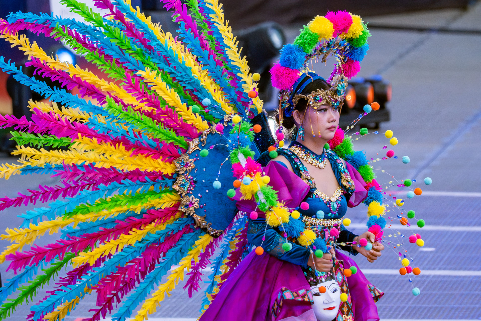 Spectrum. A performer wears the full spectrum through the parade; colour itself becomes the subject. Chingay Parade, Singapore, 2026