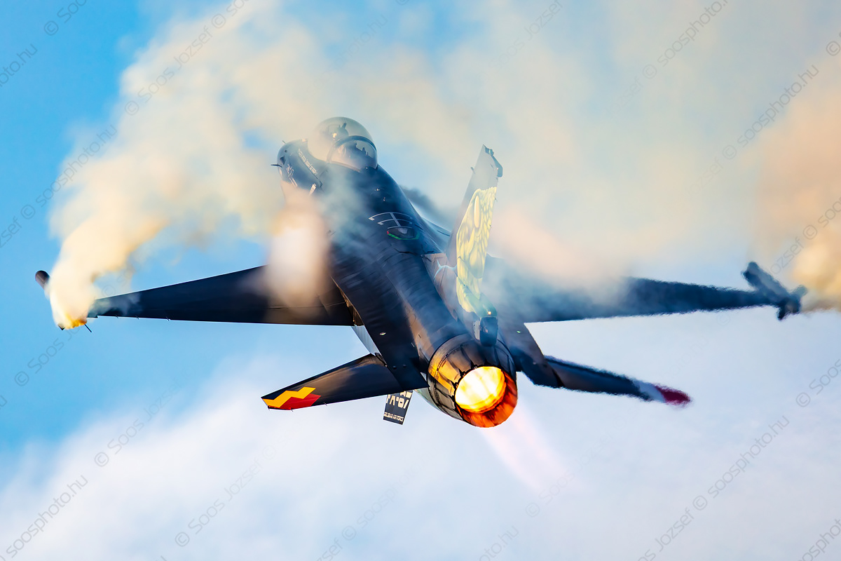 Belgian Air Force F-16C fighter jet in an aggressive climb with full afterburner