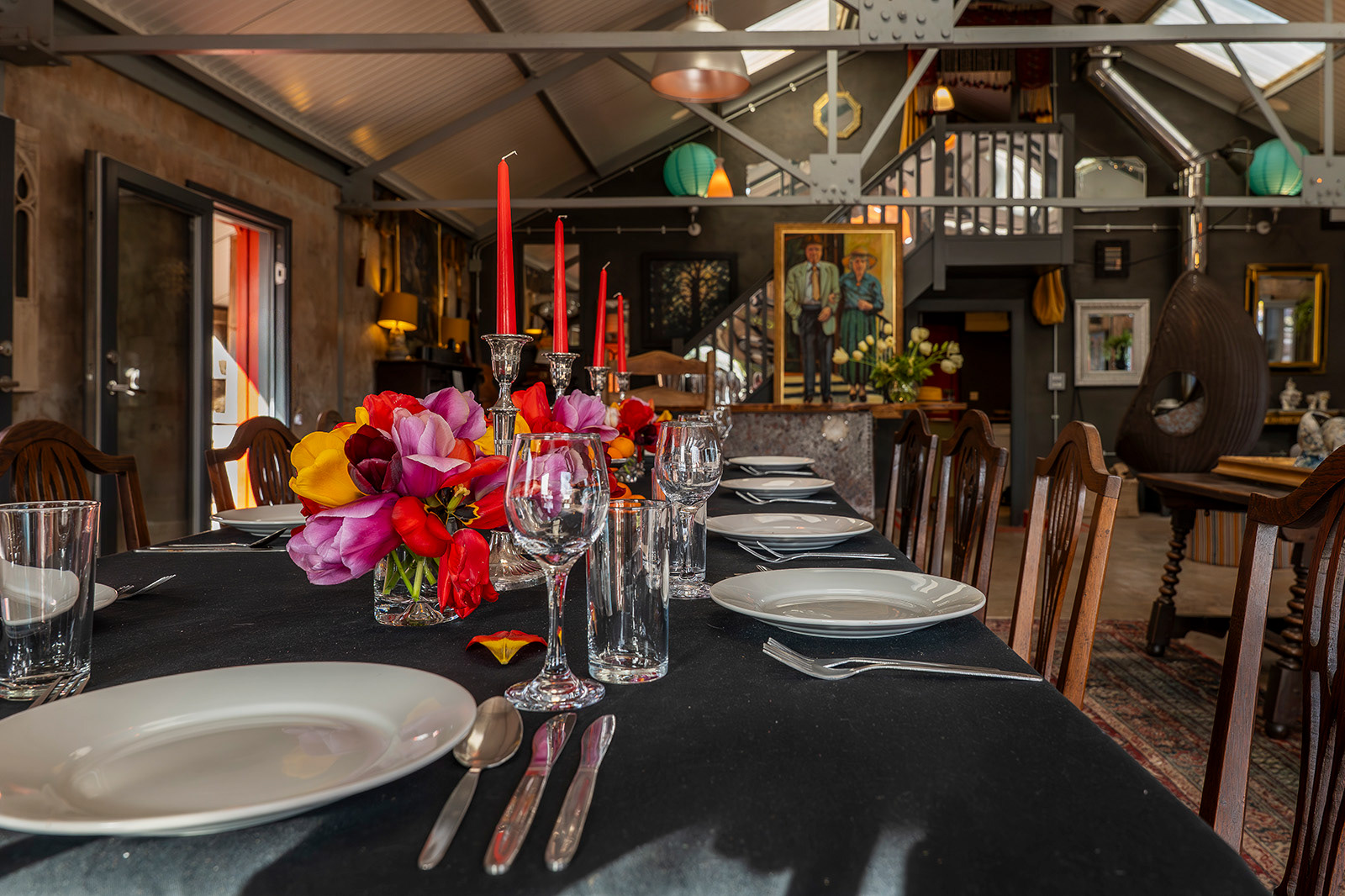 Hospitality photography of The Pavilion at Woodlands Farm Wales, showcasing a beautifully prepared dining table with fresh tulips, candles and tableware, ready for guests to gather and enjoy.