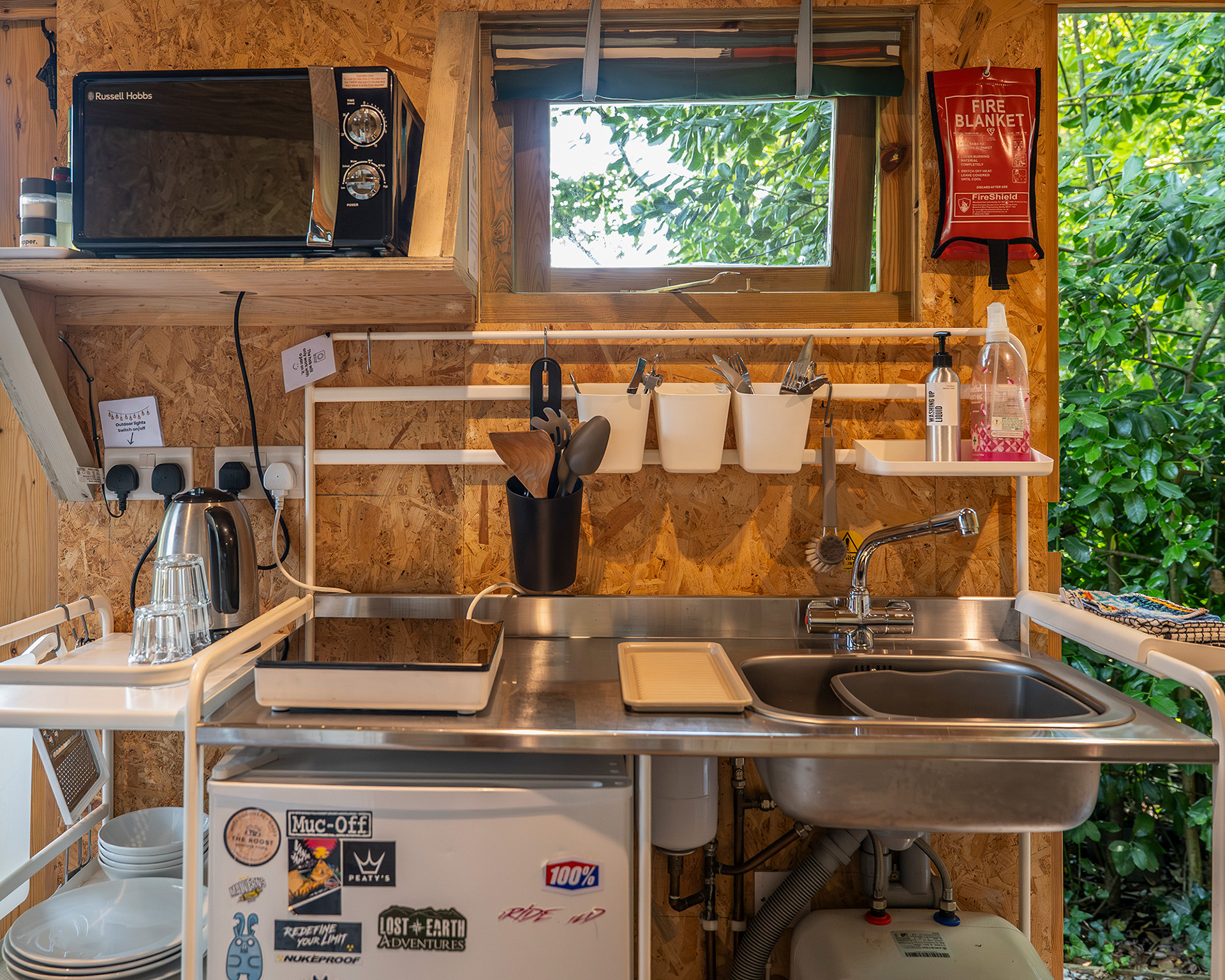The compact, well-equipped kitchen inside Arosfa cabin at Roost Merthyr Tydfil, designed to provide everything guests need for comfortable self-catering during a glamping stay in South Wales.