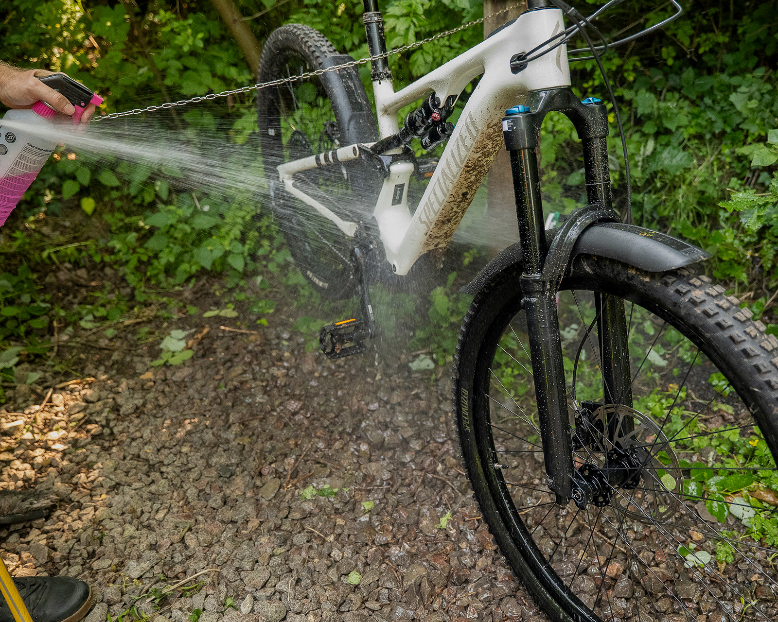 Cleaning a muddy bike at Roost Merthyr Tydfil, with the bike wash area providing a practical facility for guests exploring the South Wales countryside by bike.