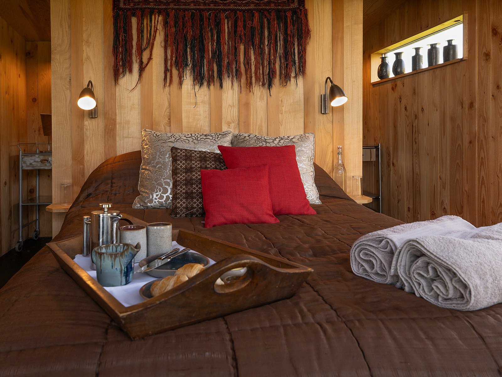 Hospitality photography of Bivouac at Woodlands Farm Wales, showcasing the cosy wood-panelled interior, breakfast details and colourful styling of this luxury glamping accommodation in the Welsh countryside.