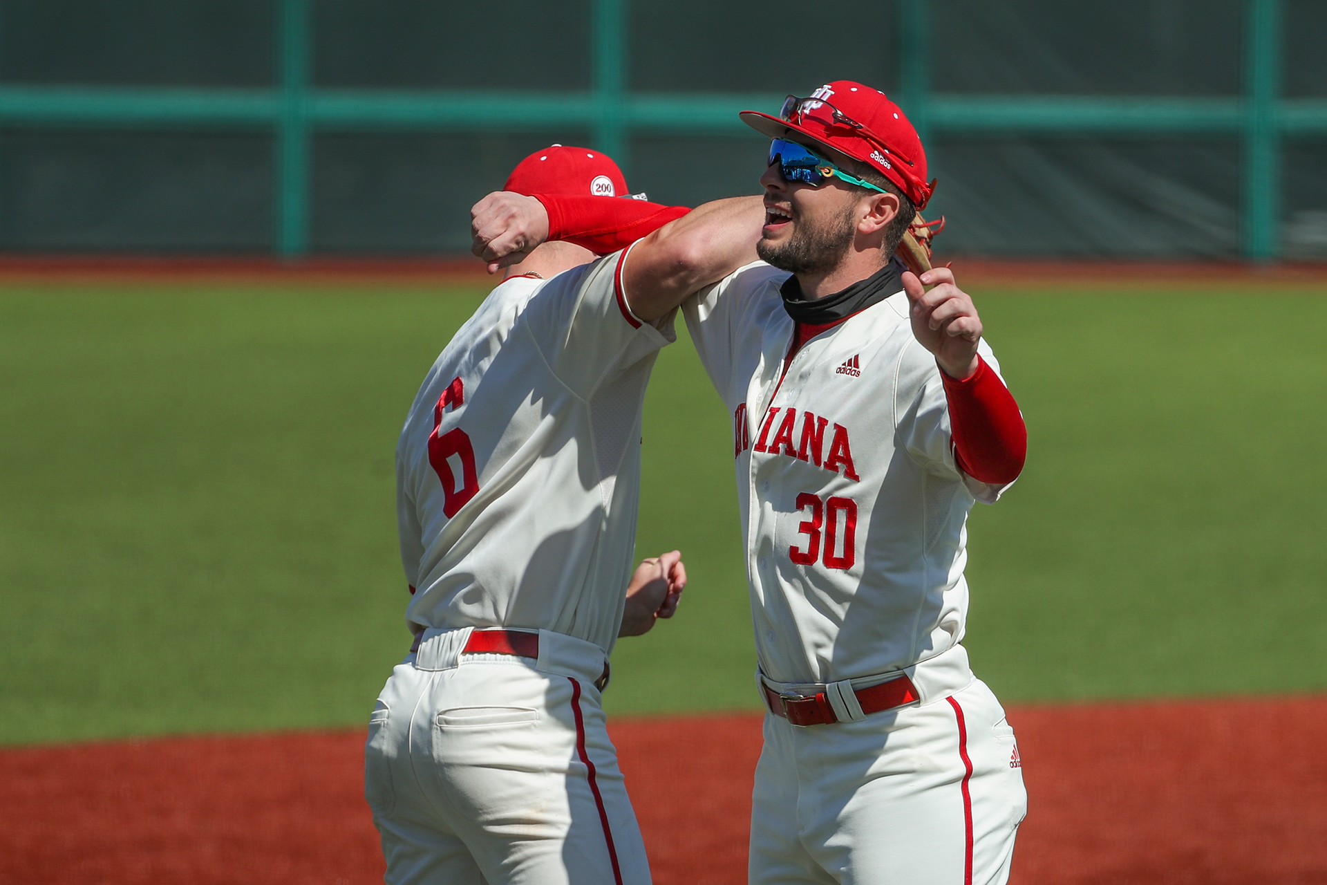 BLOOMINGTON, IN - March 20, 2021 -  Outfielder Grant Richardson #6 and Infielder Kip Fougerousse #30 of the Indiana Hoosiers interact before the game between the Purdue Boilermakers and the Indiana Hoosiers at the Bart Kaufman Field in Bloomington, IN. 