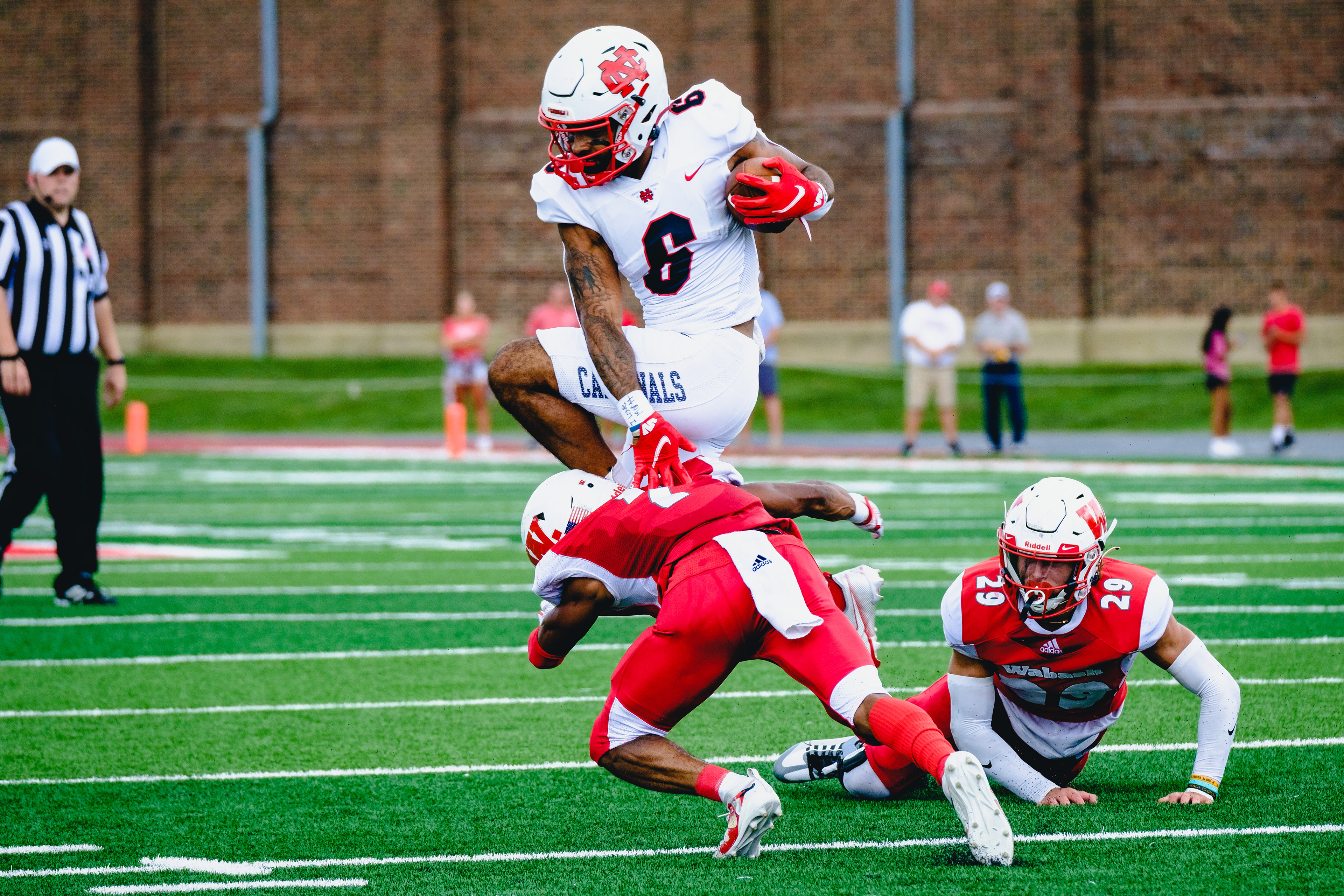 CRAWFORDSVILLE, IN – September 10, 2022 – Wide Receiver DeAngelo Hardy #6 of the North Central Cardinals jump over a Wabash Little Giant during the game against the North Central Cardinals and the Wabash Little Giants at Little Giant Stadium in Crawfordsville, IN. 