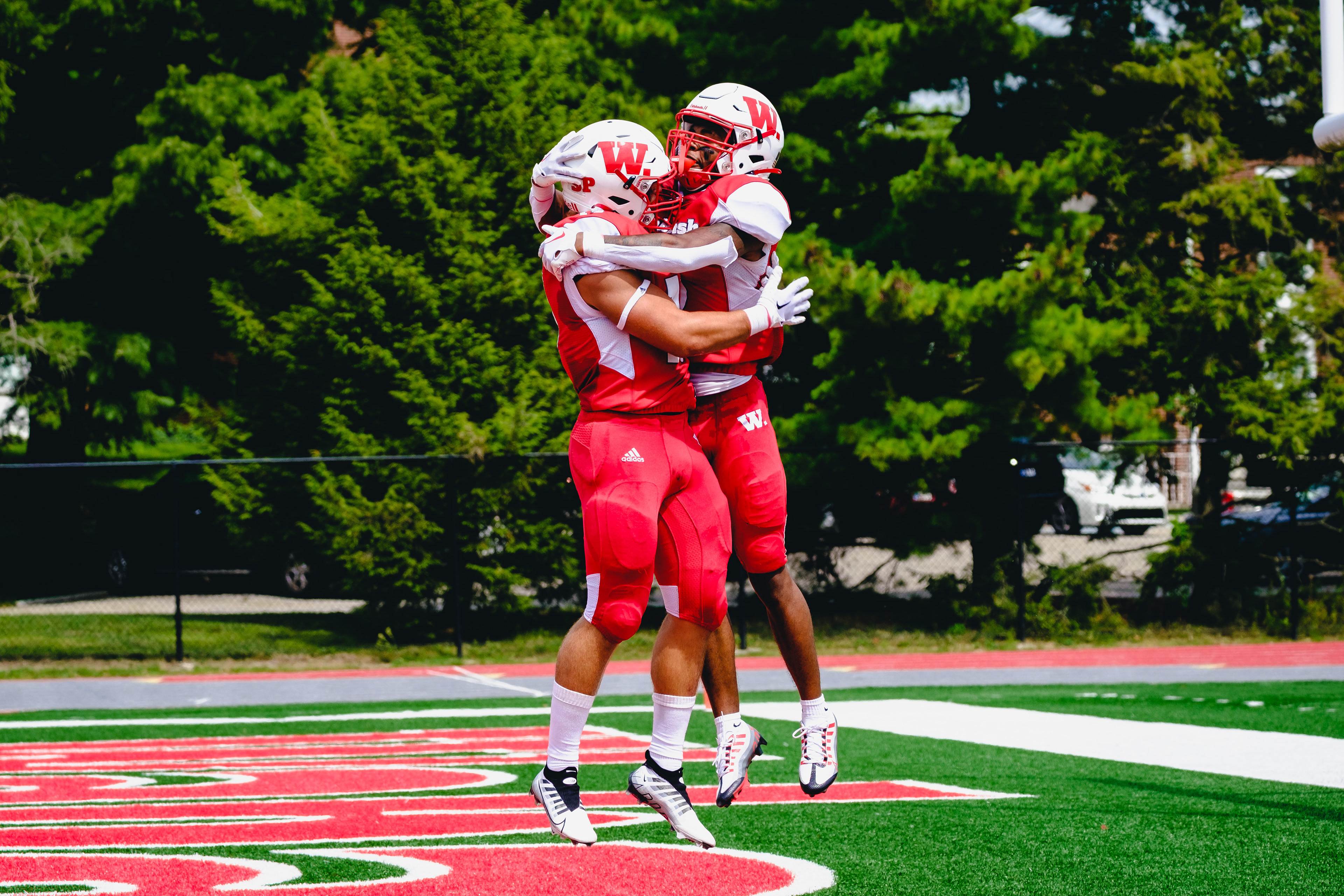 CRAWFORDSVILLE, IN – September 03, 2022 – Wide Receiver Derek Allen Jr. #3 and Quarterback Liam Thompson #2 of the Wabash Little Giants hug during the game against the Hampden-Sydney Tigers and the Wabash Little Giants at Little Giant Stadium in Crawfordsville, IN. 