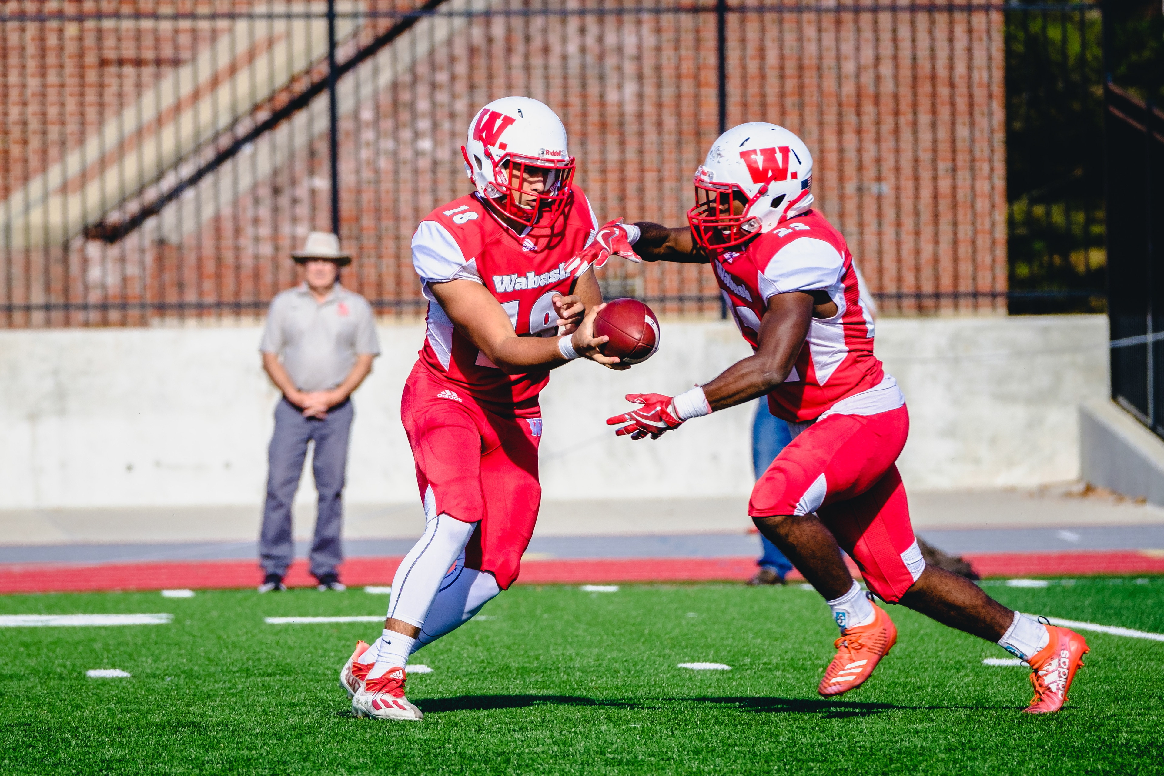 CRAWFORDSVILLE, IN – 10.29.2022 – Quarterback Blake White #18 of the Wabash Little Giants passes the ball to Running Back Xavier Tyler #22 during the game against the Hiram Terriers and the Wabash Little Giants at Little Giant Stadium in Crawfordsville, IN. 