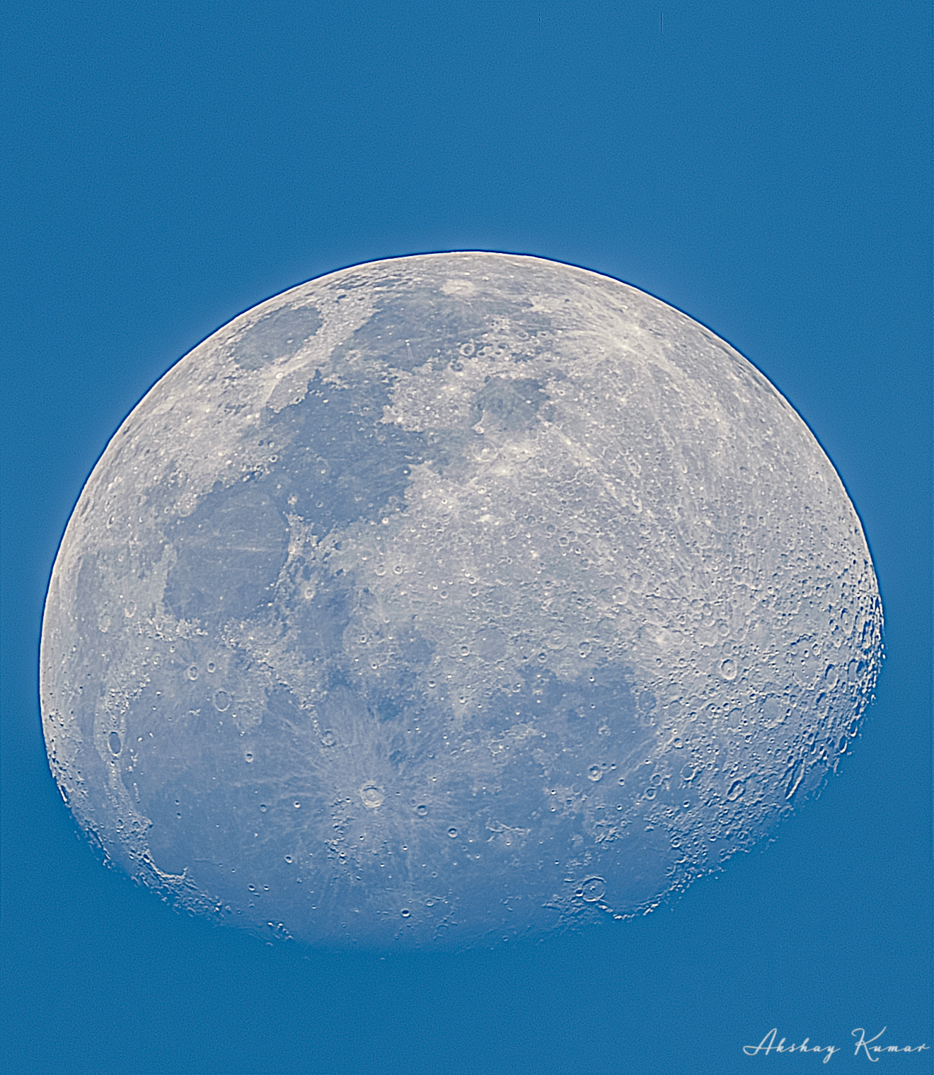 Close view of the surface of moon revealing its textures during early evening
