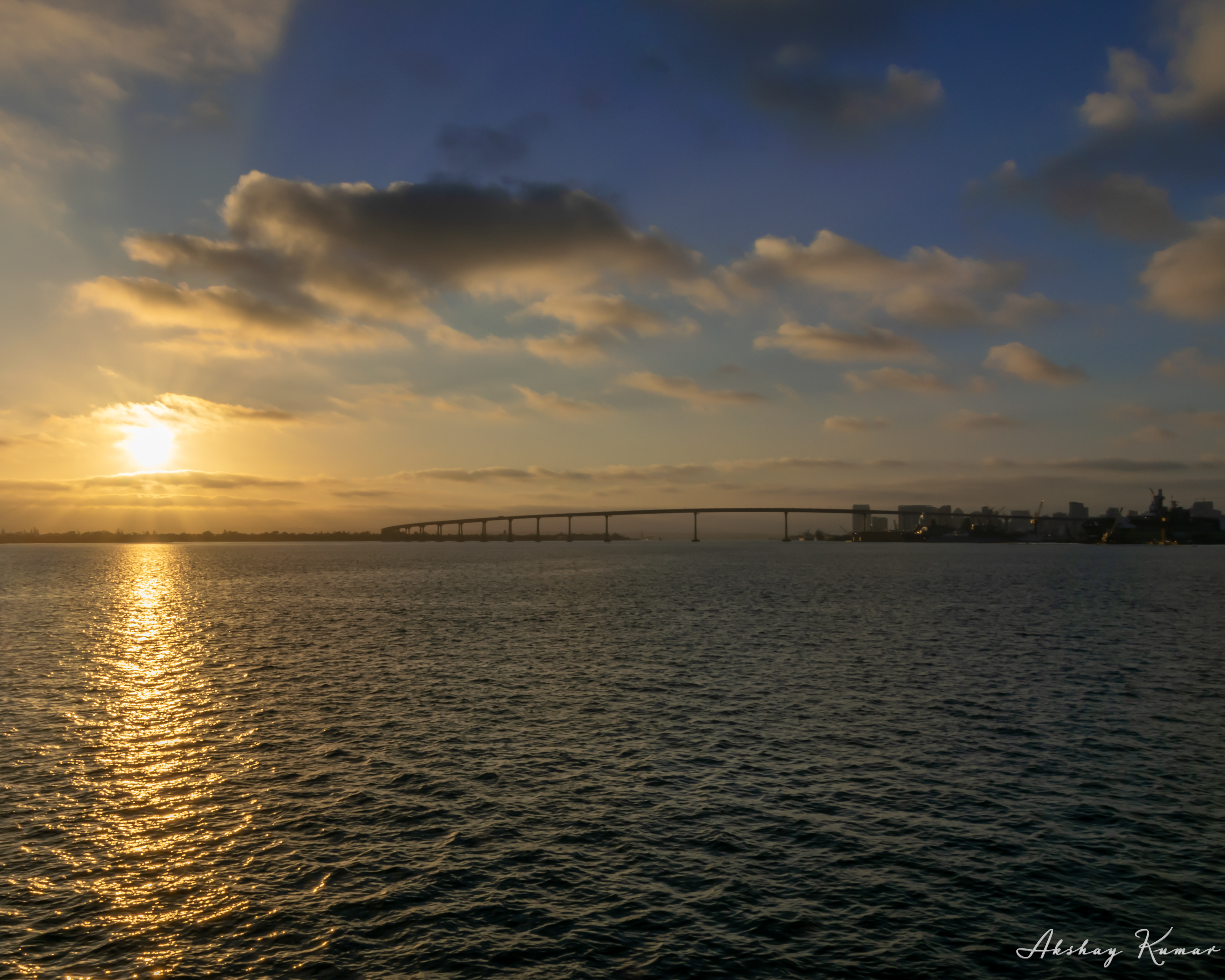 Sunset view from a cruise with Coronado bridge and San Diego skylne