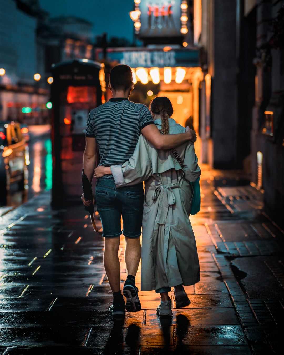A couple walking together in wet streets of London