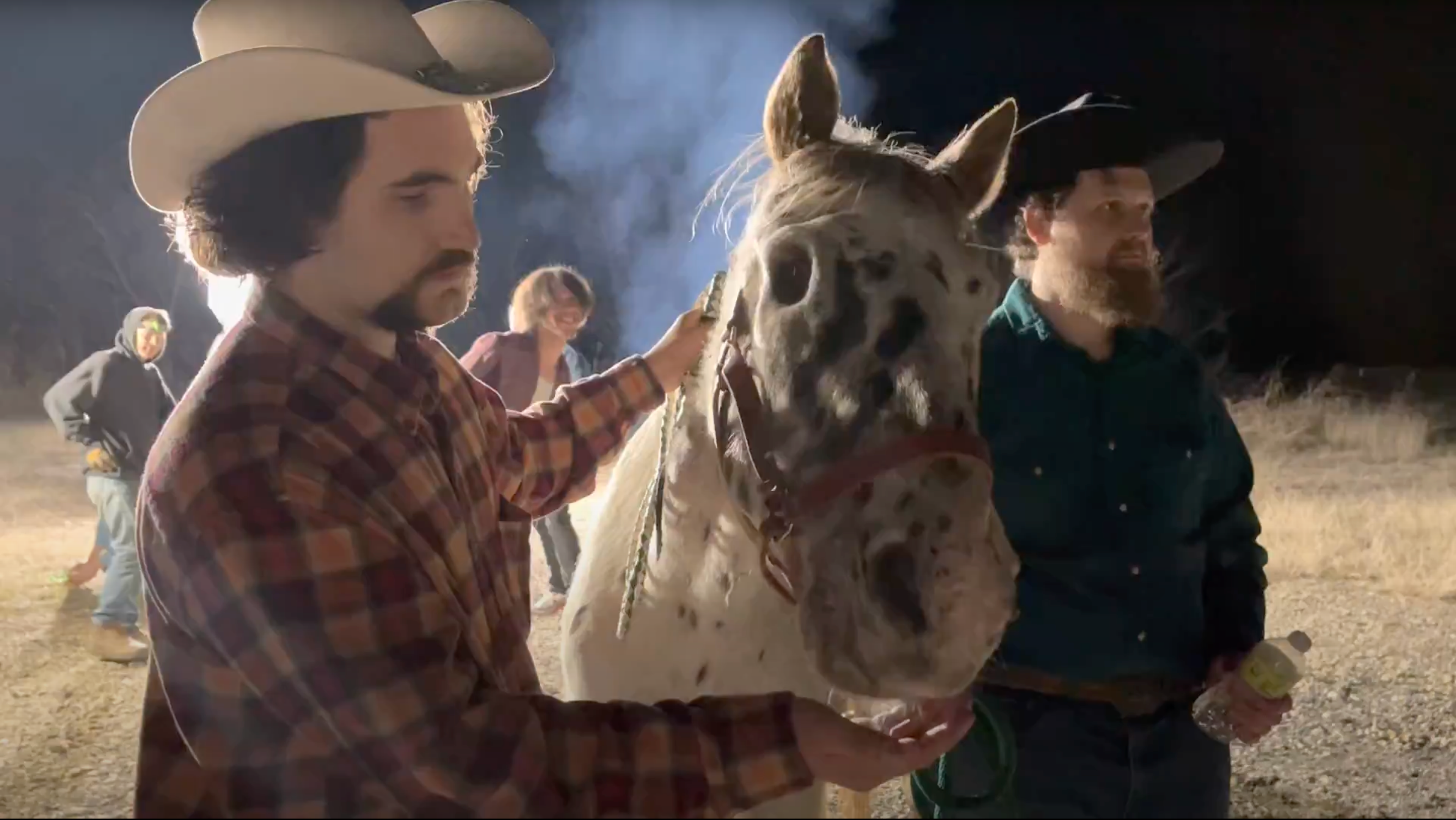 Behind the scenes photo of Sam Casey petting a blind horse next to Jozey Jezek on the set of "The Gift"